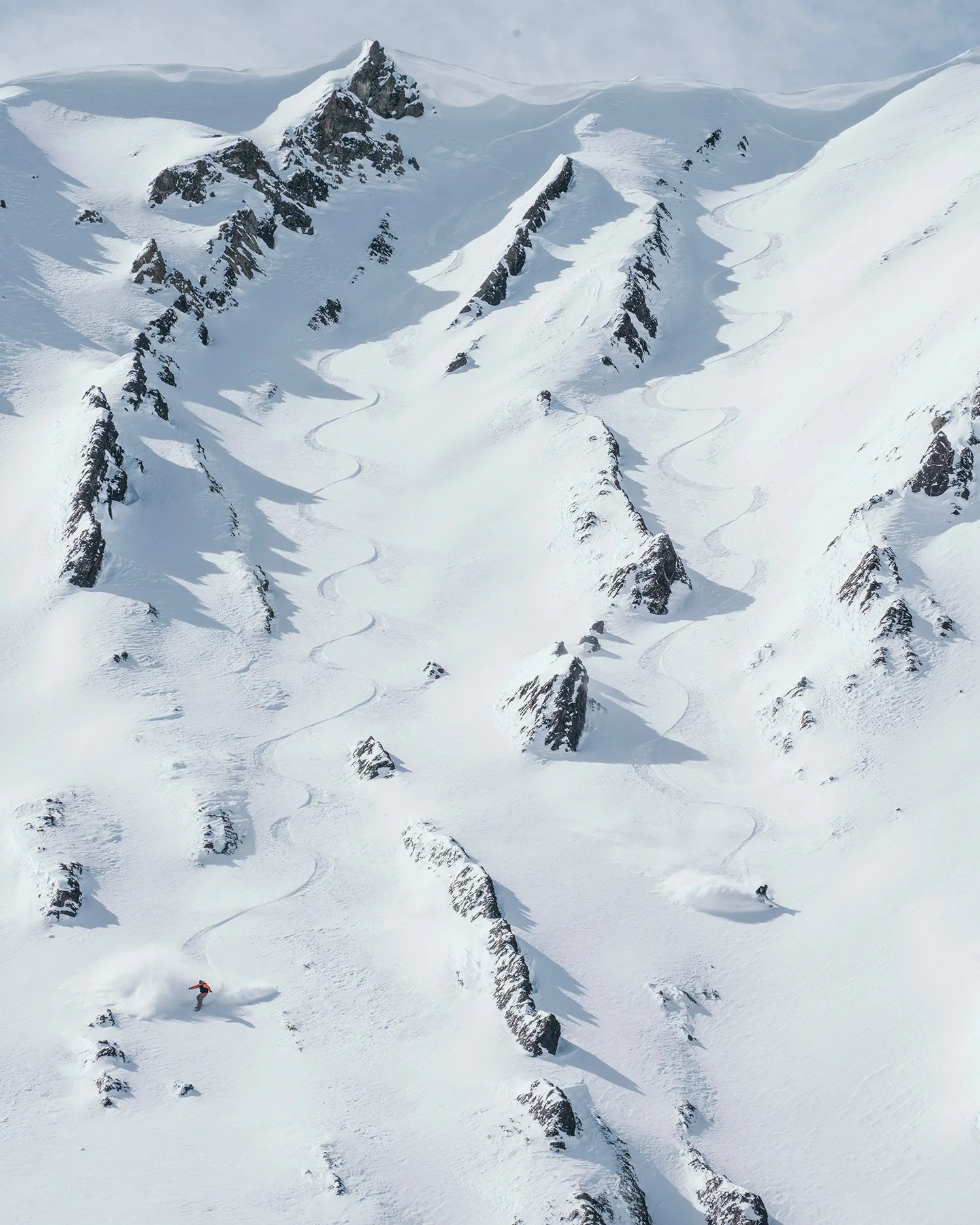 skiing down mountain with rocks