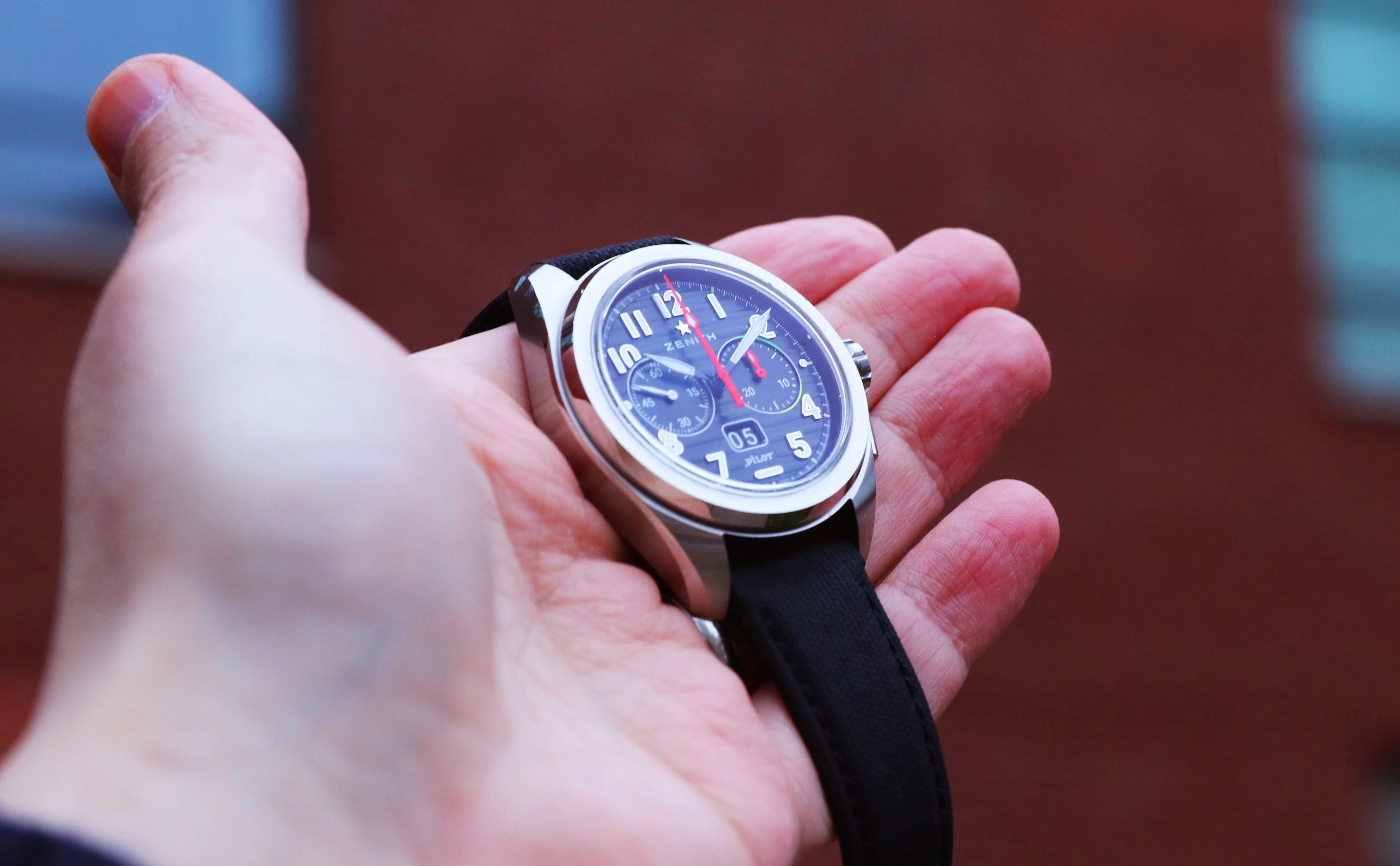 zenith watch in a mans hand