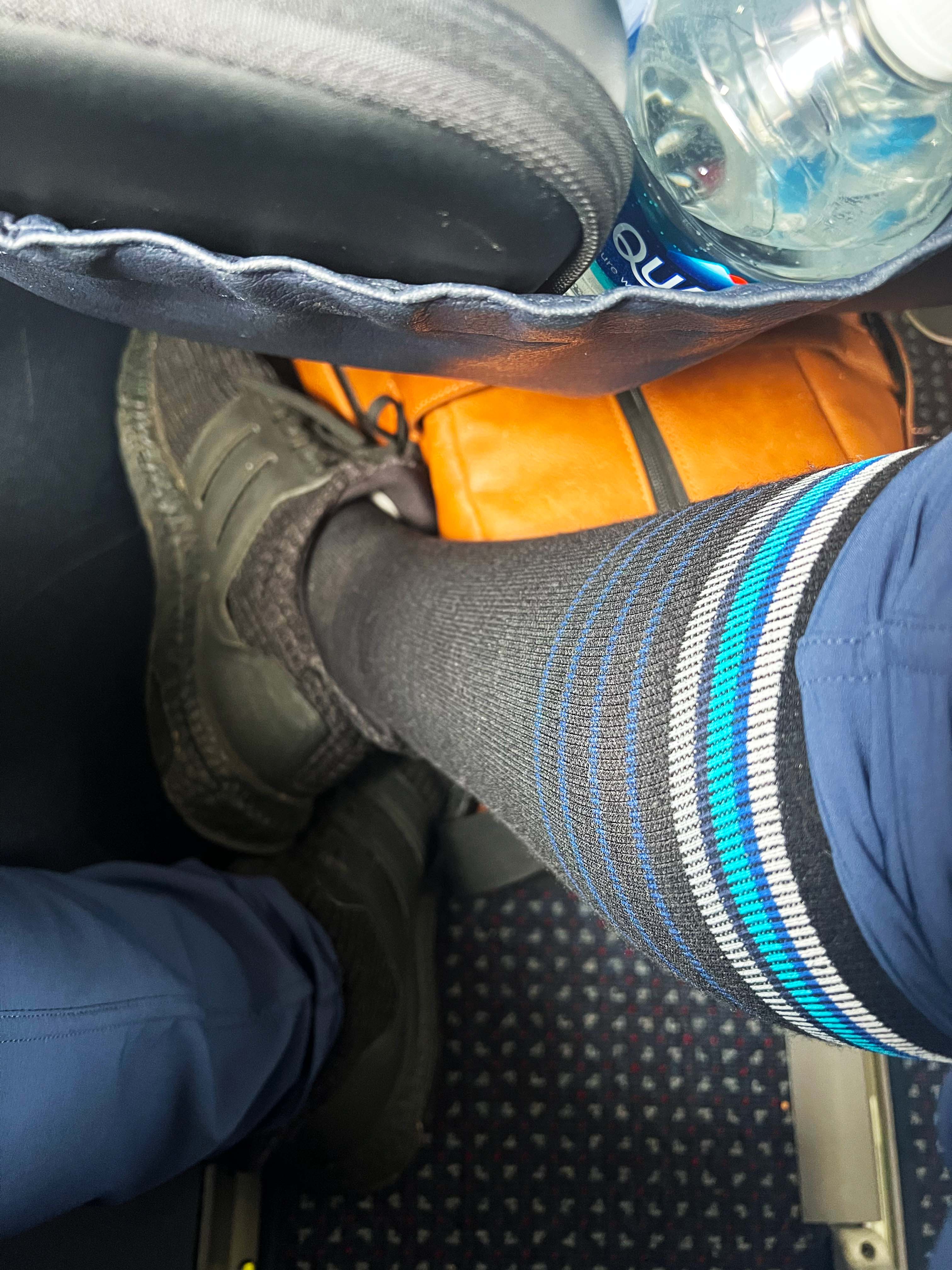 a person wears compression socks while flying