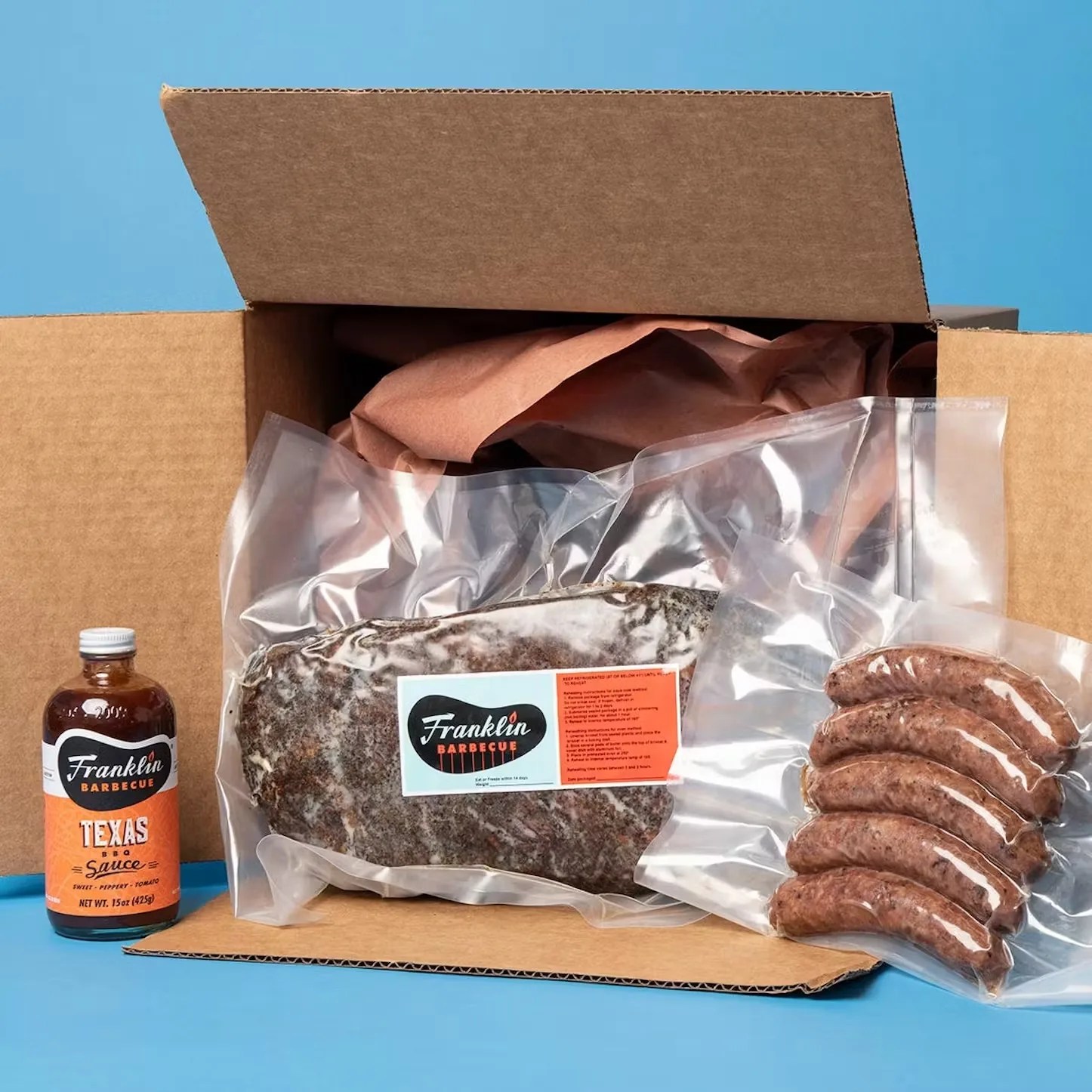 box containing franklin bbq meats