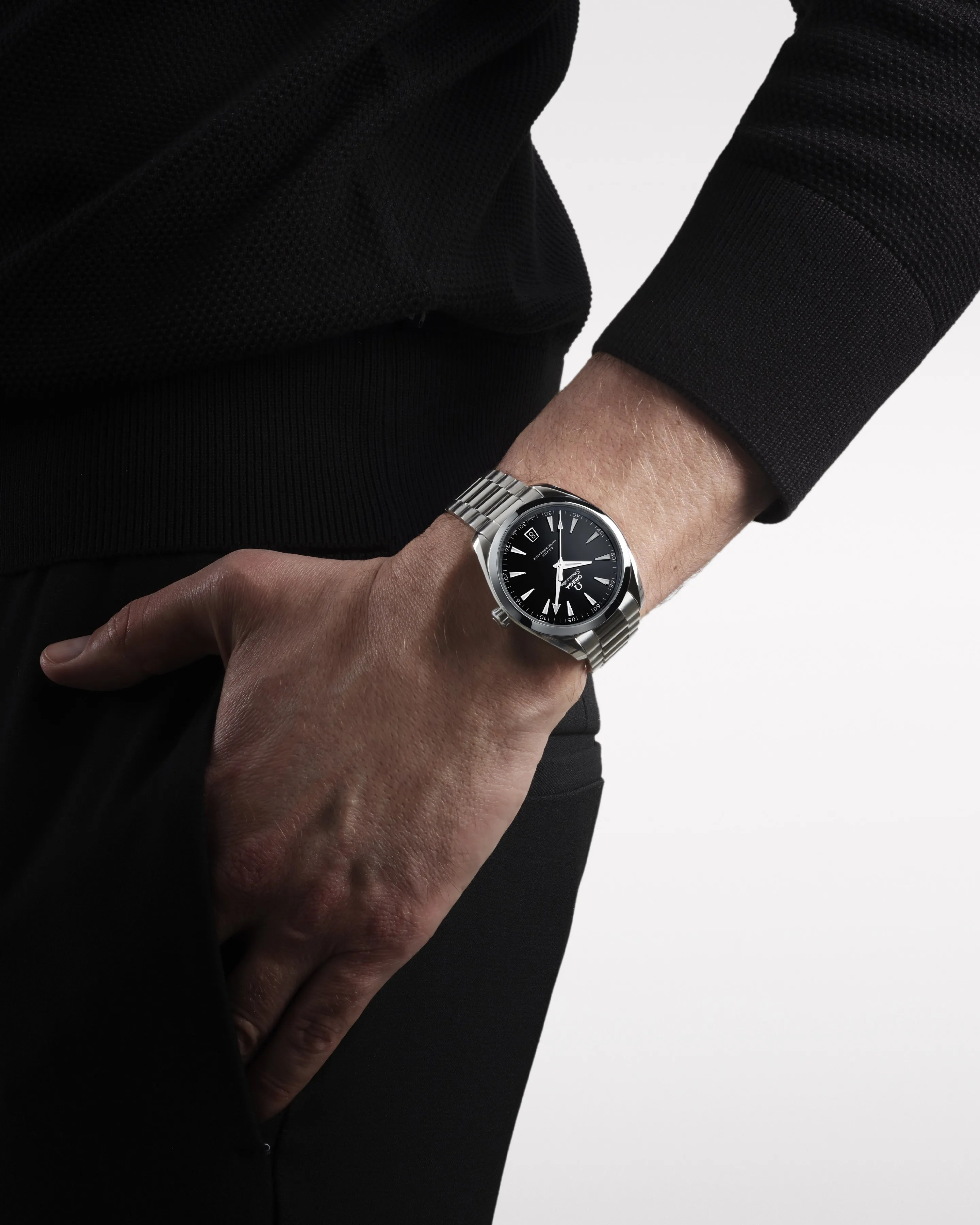 black omega watch on mans wrist
