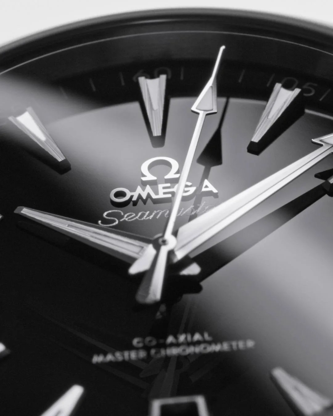 closeup of black omega watch hands