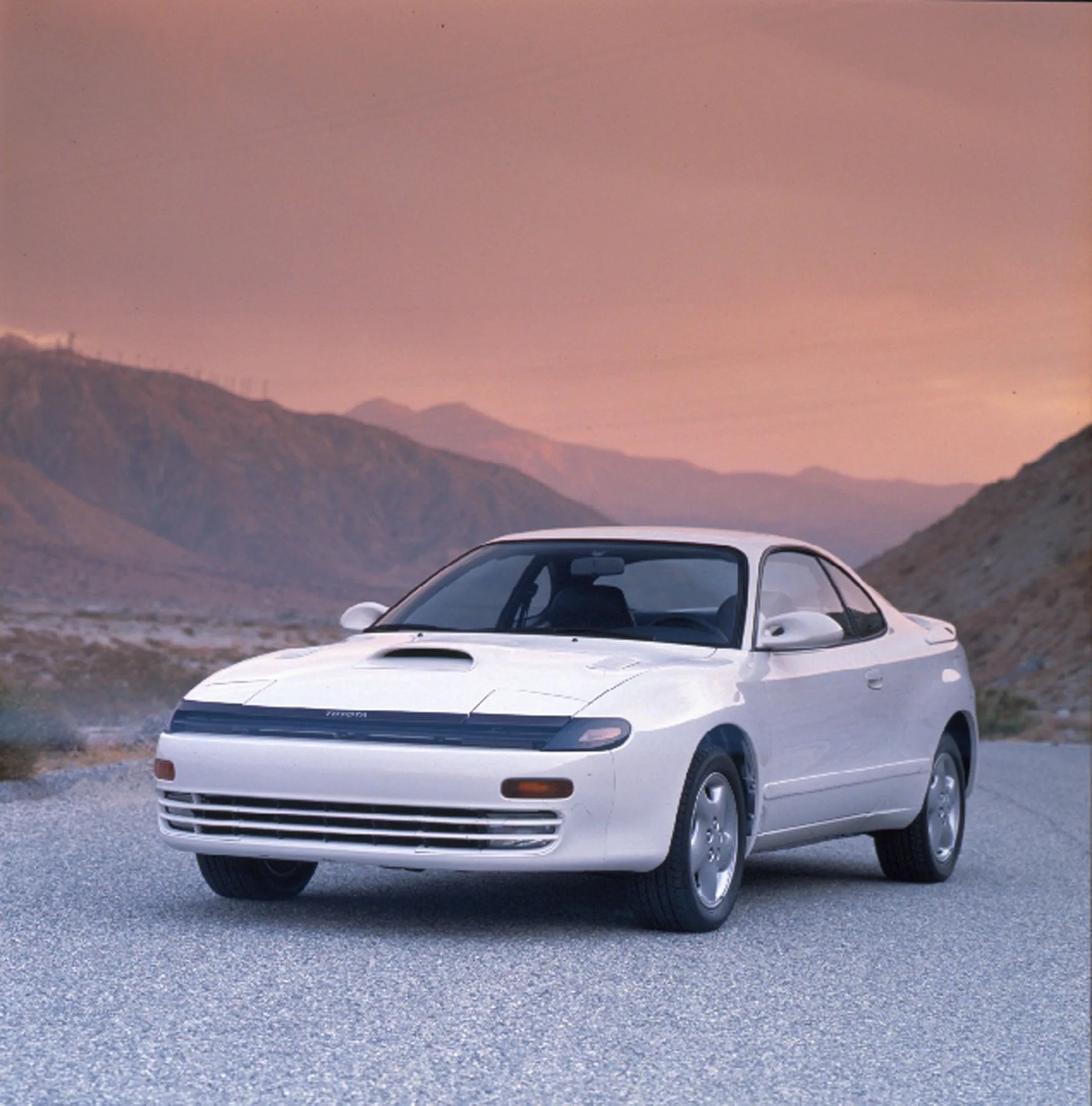 toyota celica car parked in front of mountains