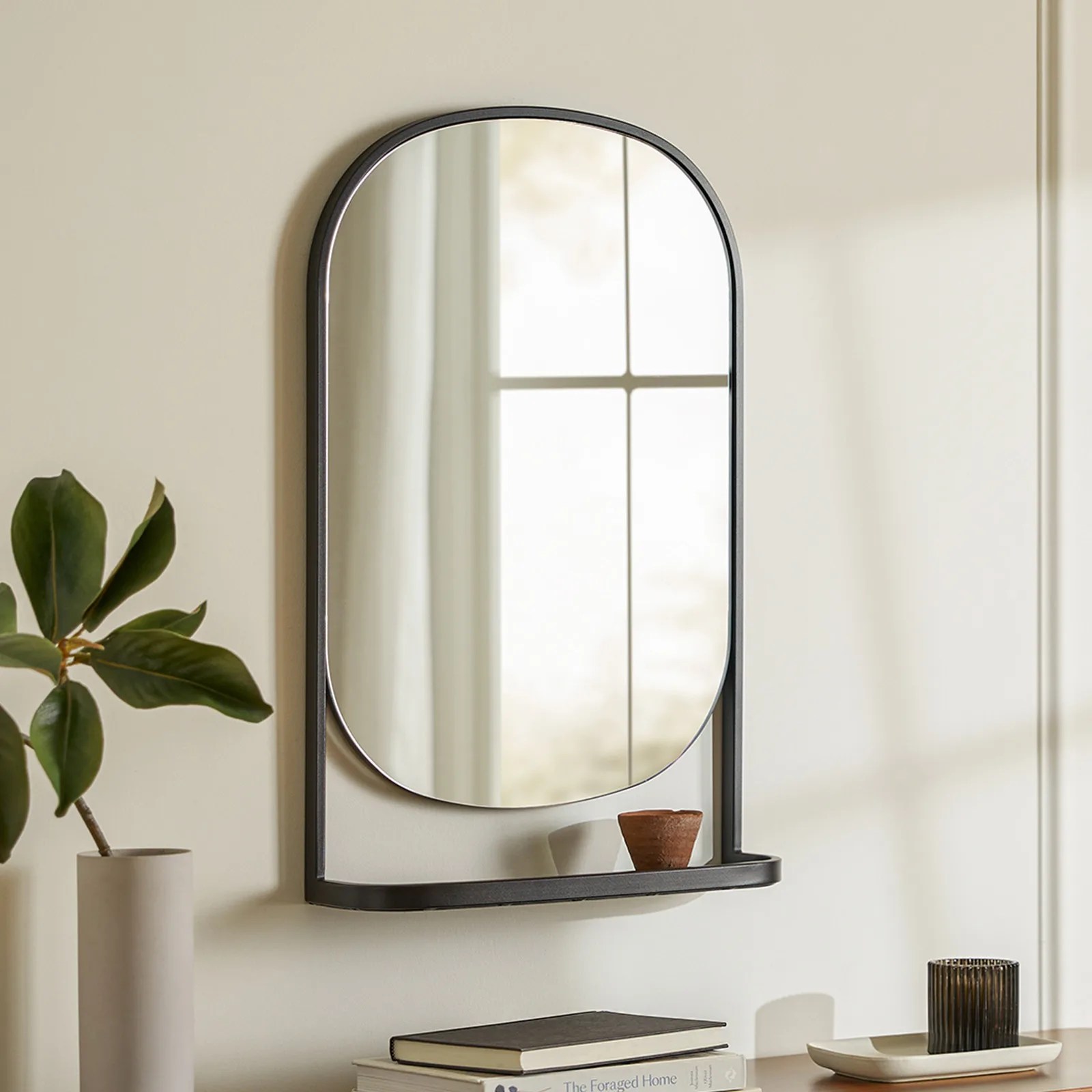 The Article Klein wall mirror and shelf shown hanging on a wall