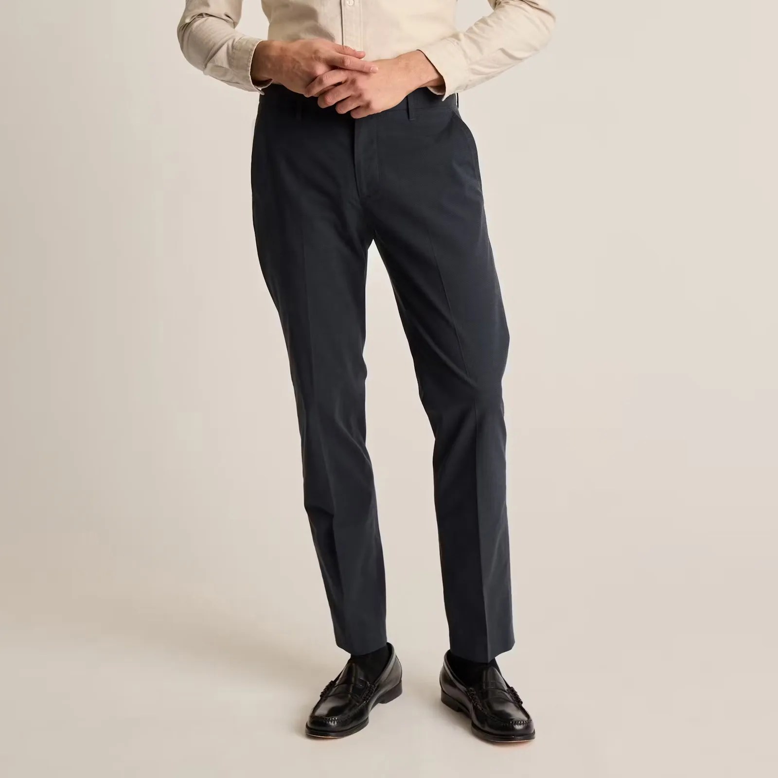 A male model wearing a pair of navy Bonobos Weekday Warrior Pants