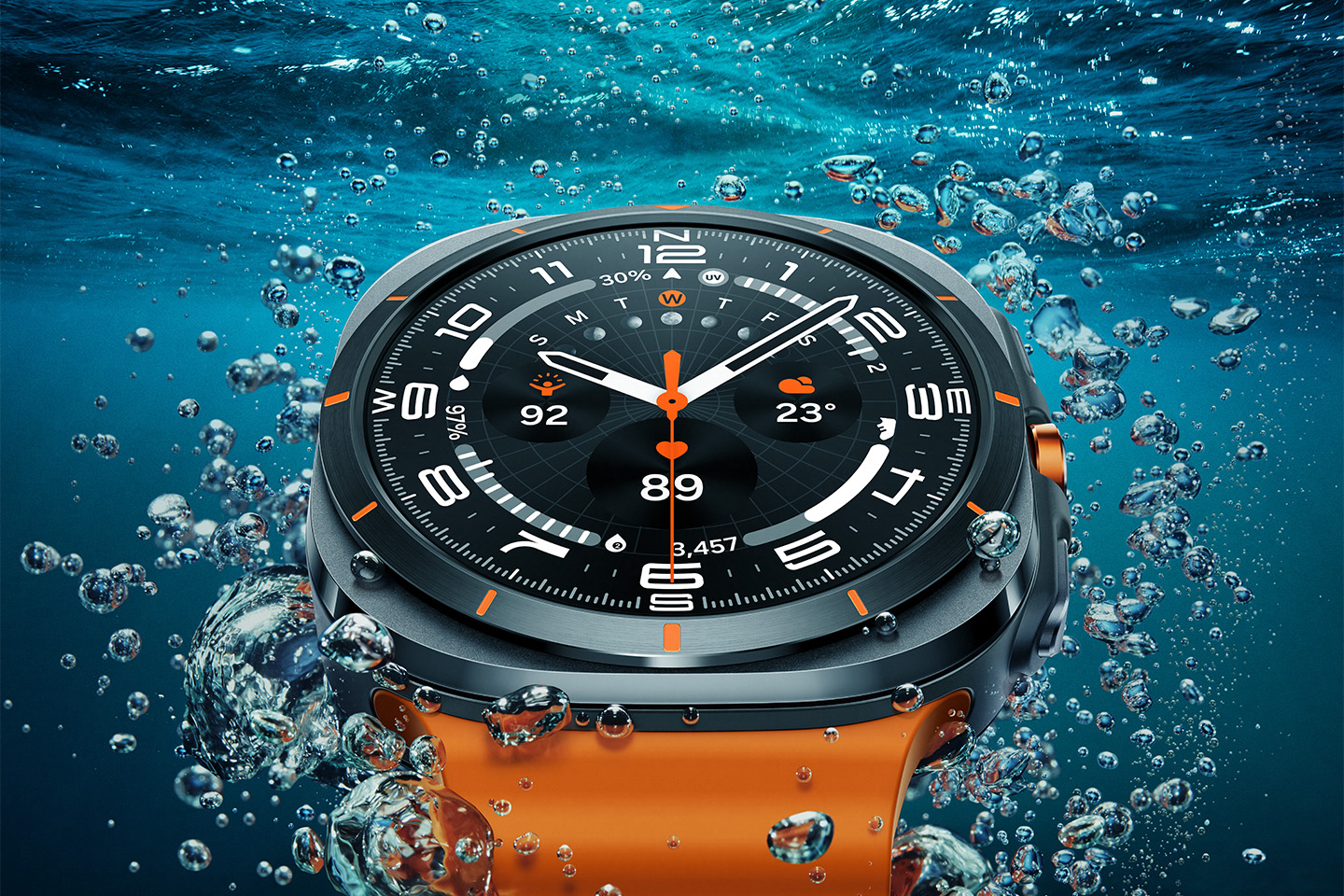 A rendering of the Samsung Galaxy Watch Ultra under water with bubbles surround the watch and its bright orange band