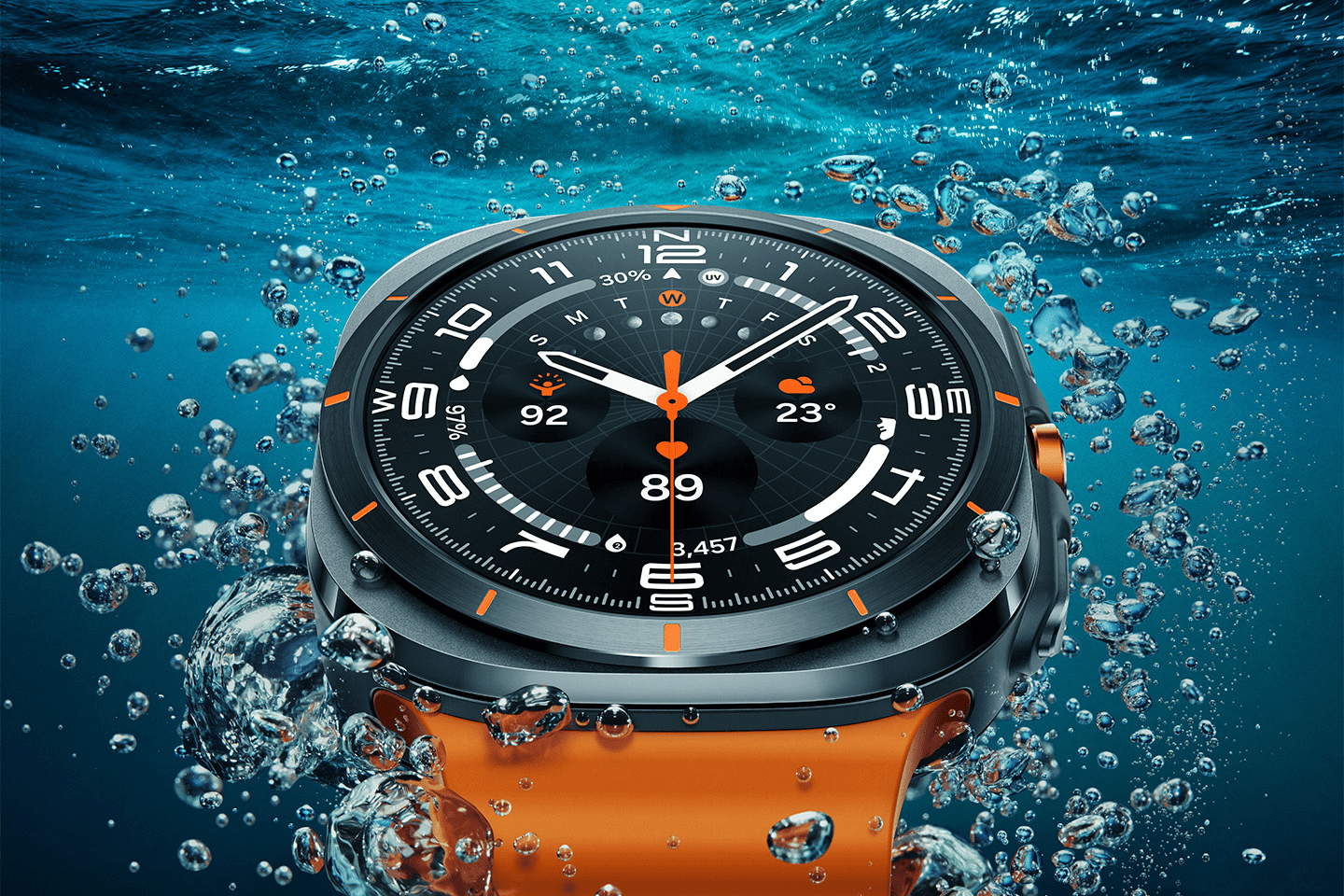 A rendering of the Samsung Galaxy Watch Ultra under water with bubbles surround the watch and its bright orange band