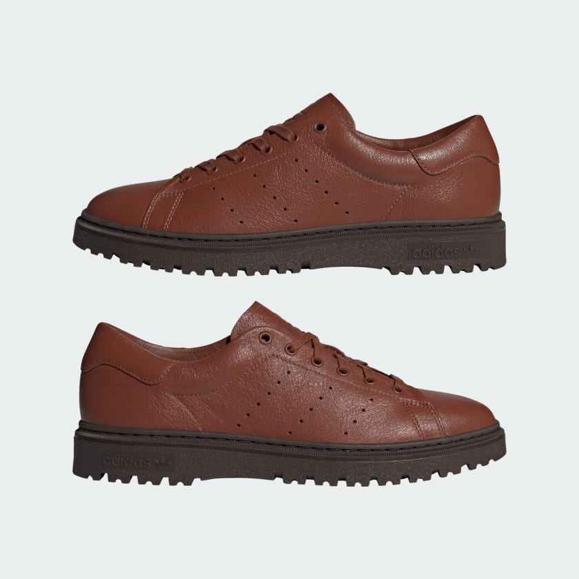 A pair of Adidas Stan Smith FREIZEIT in brown shown in profile facing different directions