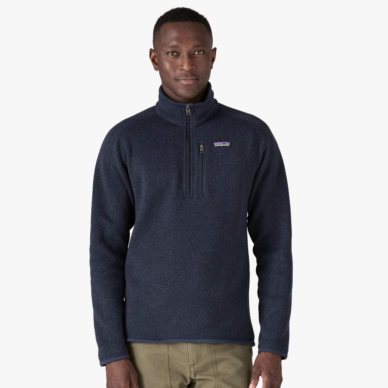 A black male wearing a Patagonia Better Sweater 1/4 fleece in dark navy staring directly ahead shown from the waist up
