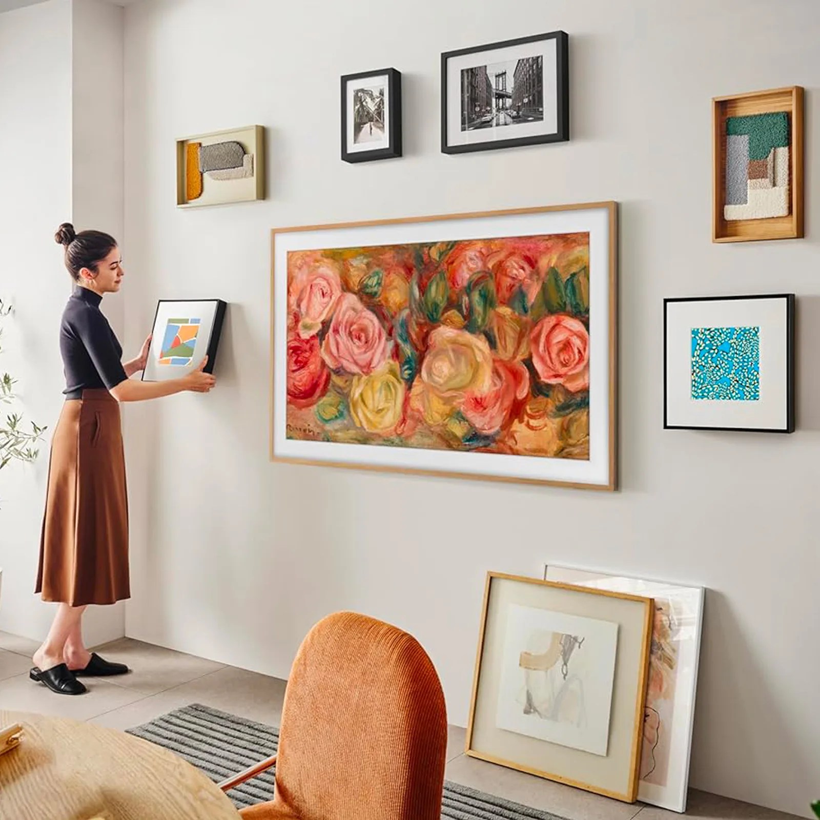 Samsung Frame TV on wall full of framed items