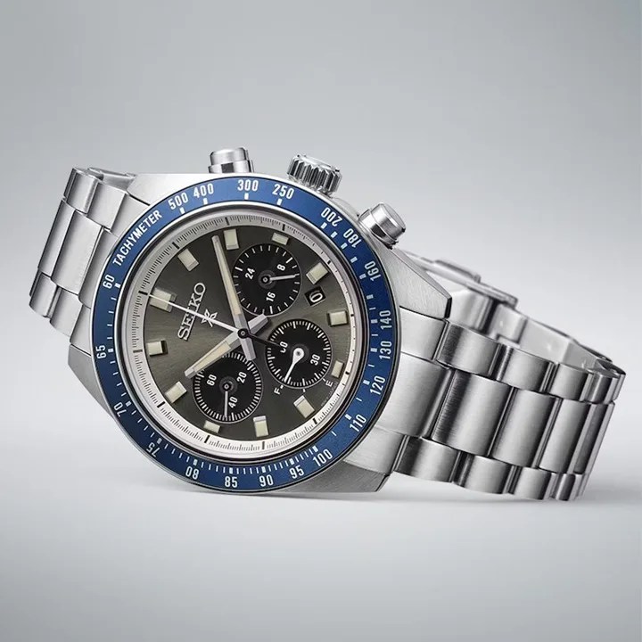 A Seiko Propsex Speedtimer Solar in blue and grey shown sitting on its side against a light grey background.
