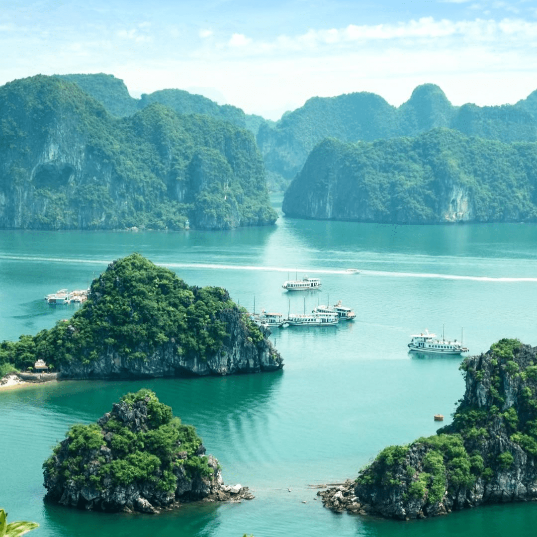 tropical lagoon with mountains and boats in the distance