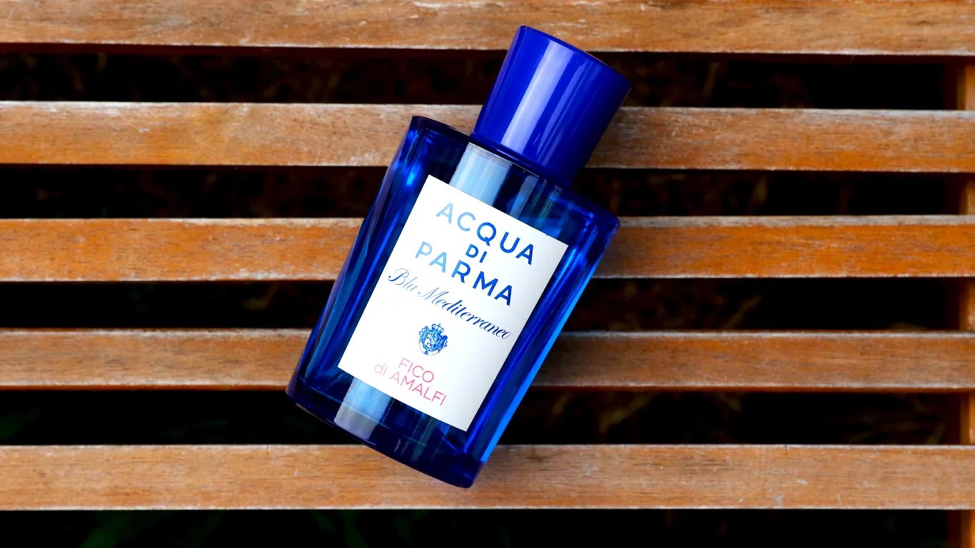 acqua di parma fragrance bottle on a slatted bench