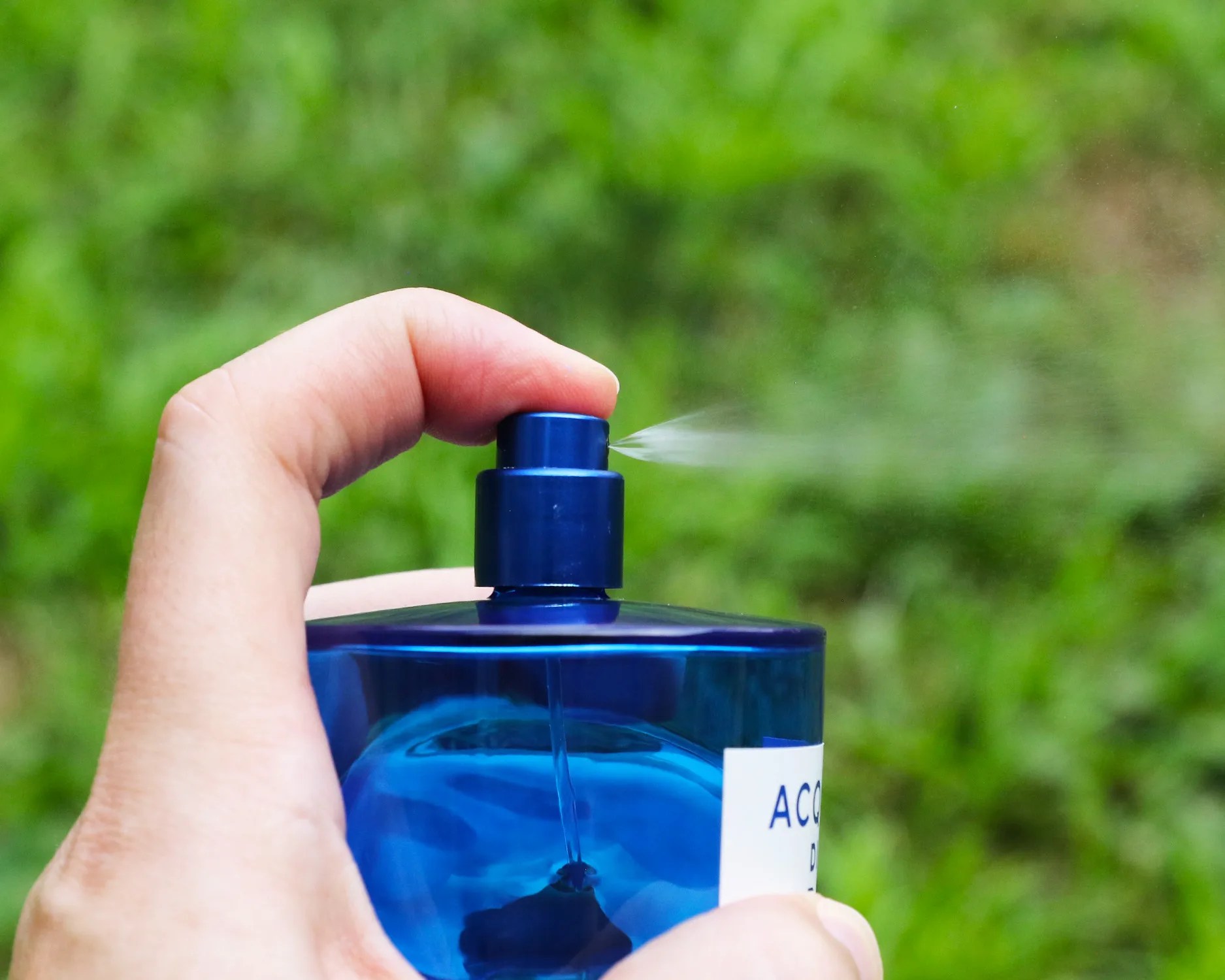 acqua di parma fragrance bottle being sprayed