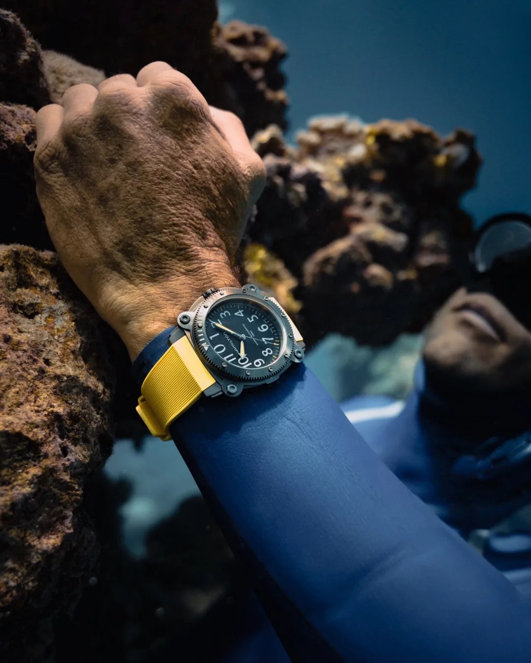a diver wears a hamilton dive watch underwater