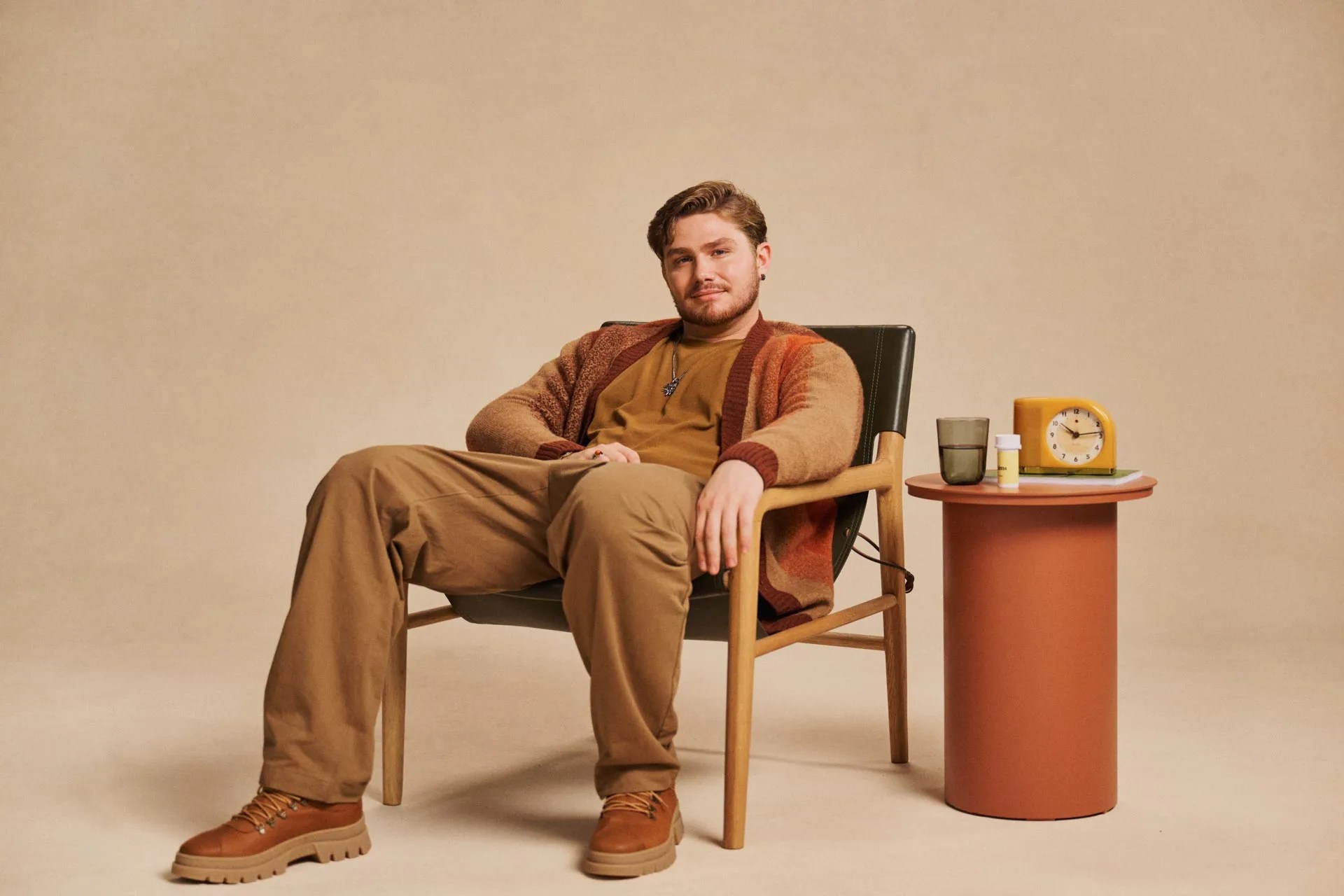 man sitting on chair with Hims