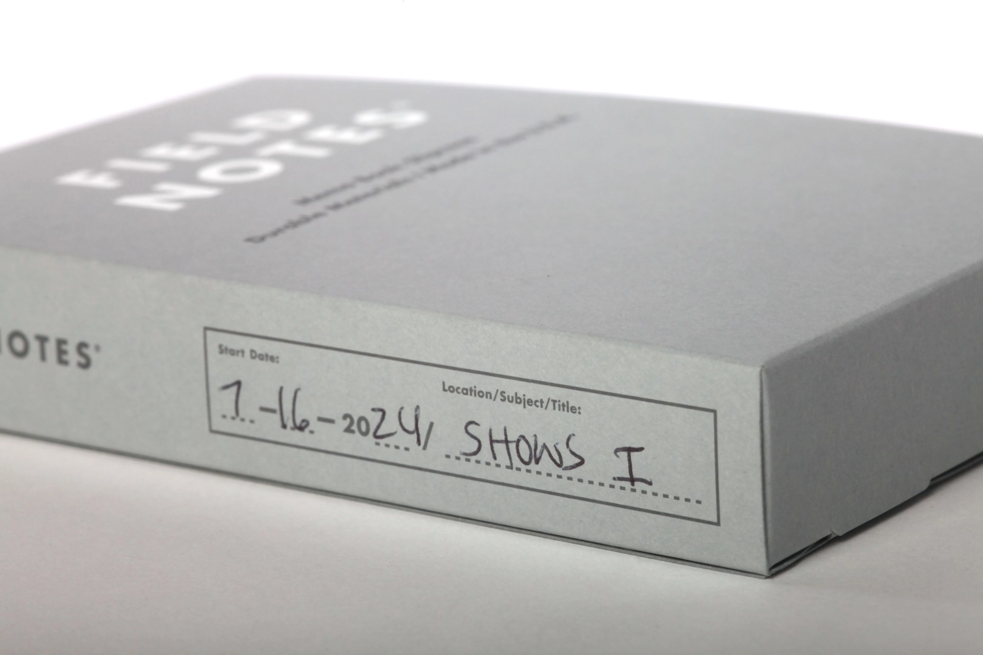 Field Notes Memo Book Slipcase show laying on its side to highlight the space on the spine for denoting information about the notebooks held inside. 