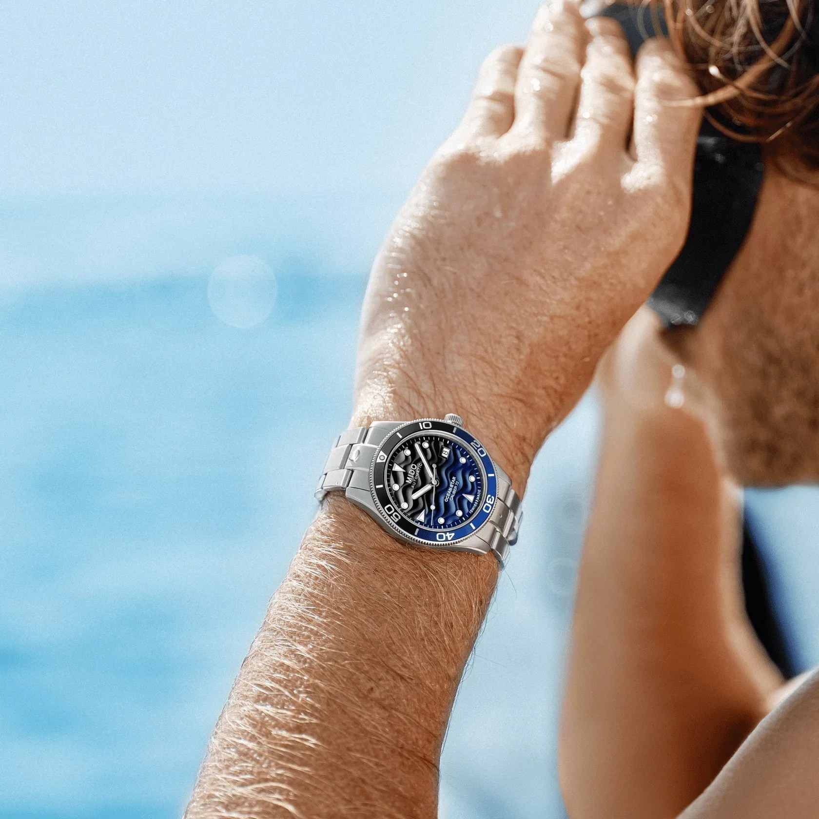 mido dive watch on mans wrist