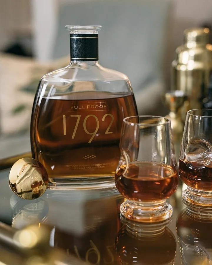 1792 bourbon bottle with two glasses of whiskey