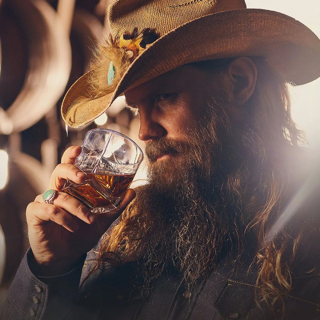 chris stapleton noses a glass of whiskey