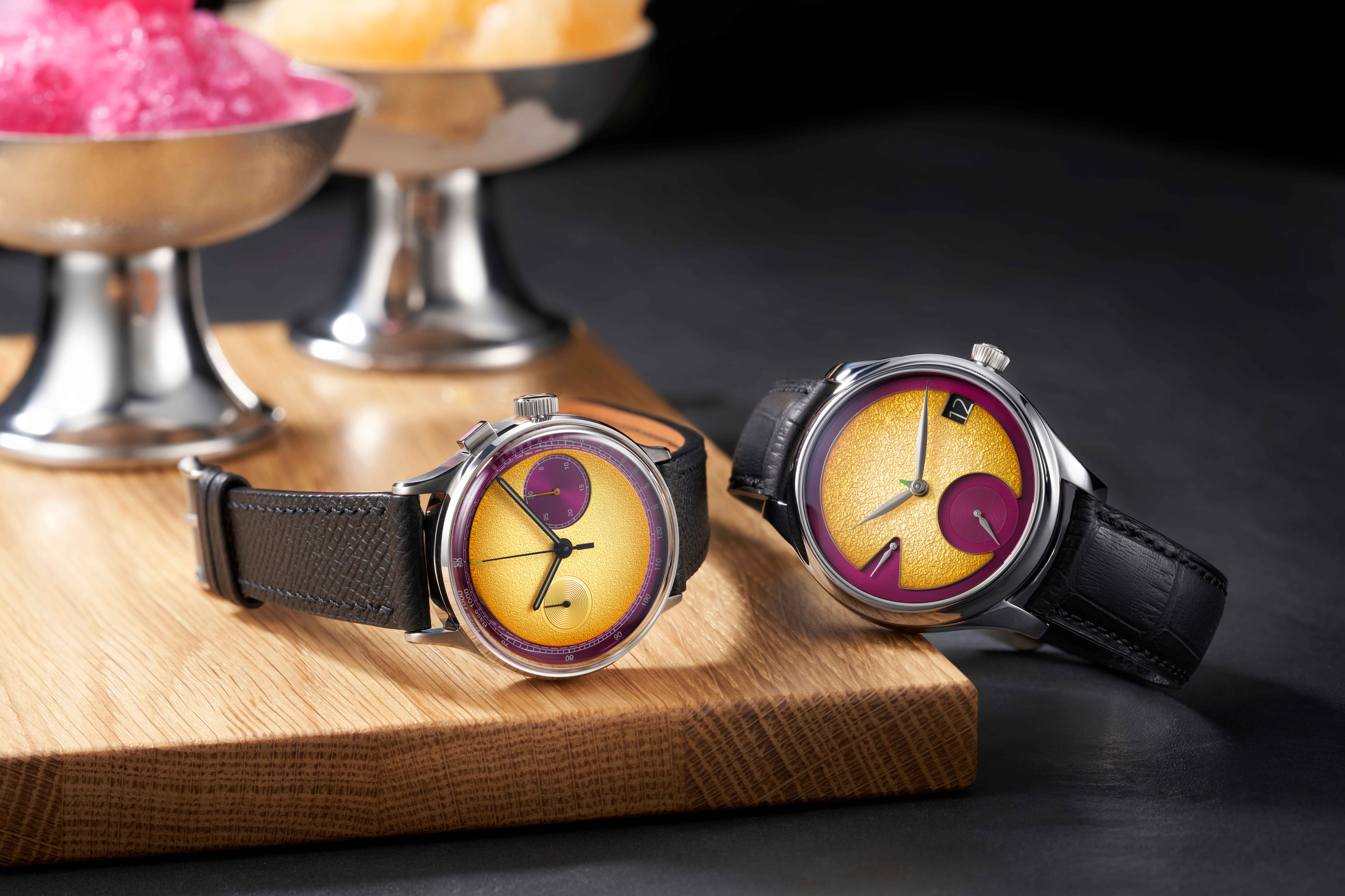 a studio underd0g watch next to a moser watch on a table