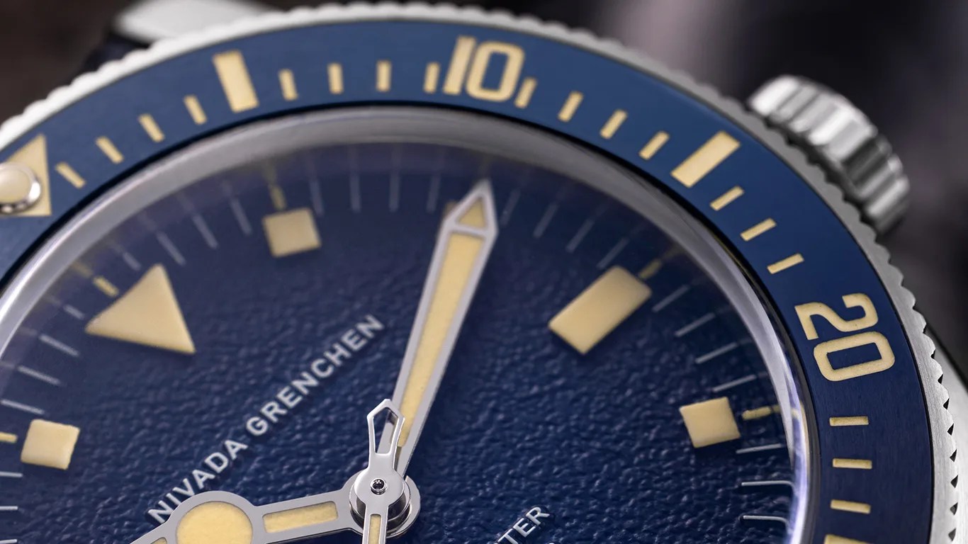closeup of a blue nivada grenchen dive watch dial