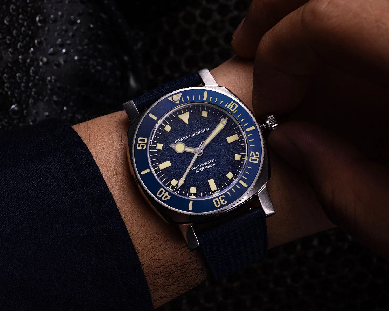 nivada grenchen dive watch on a mans wrist