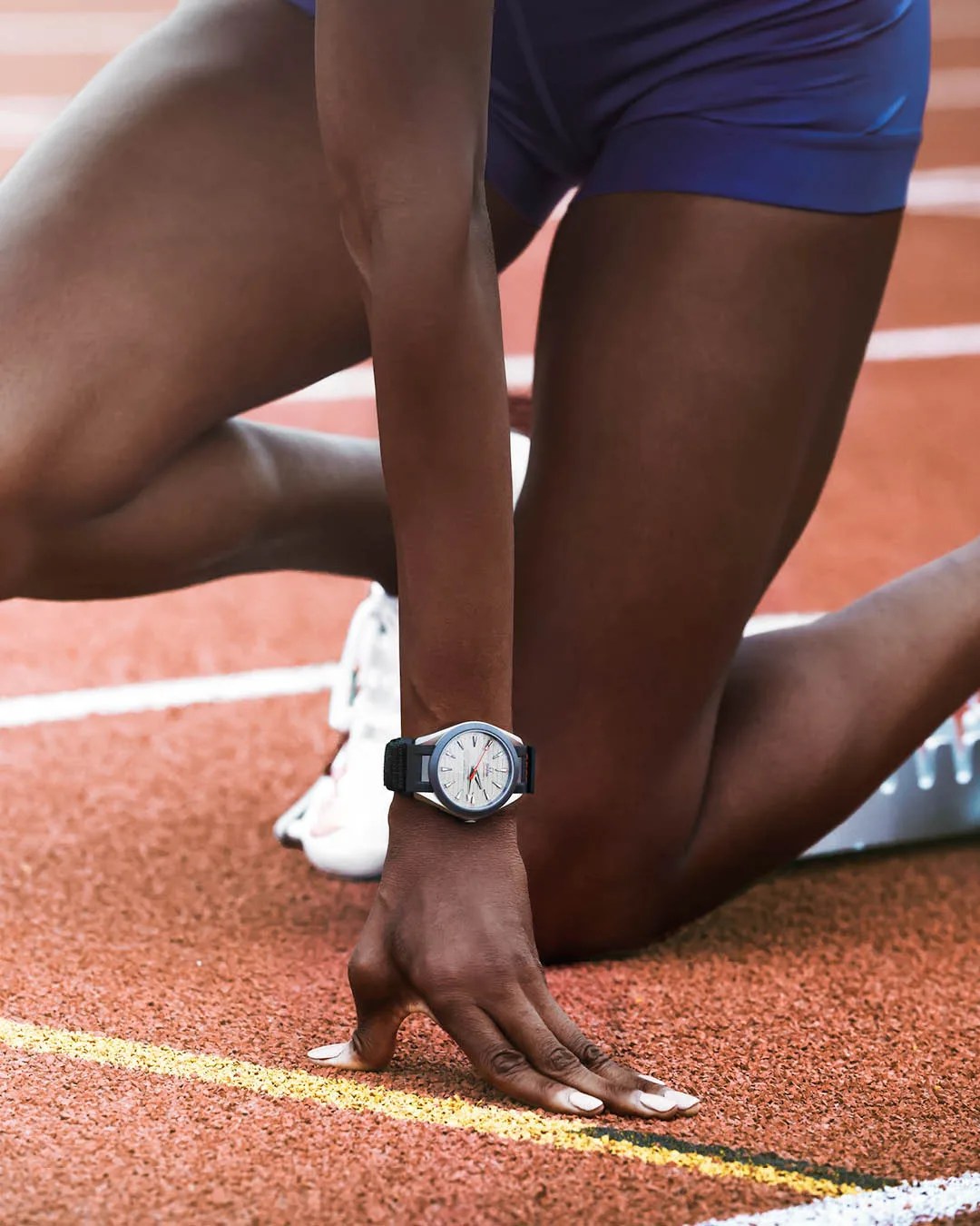 track athlete wears an omega watch