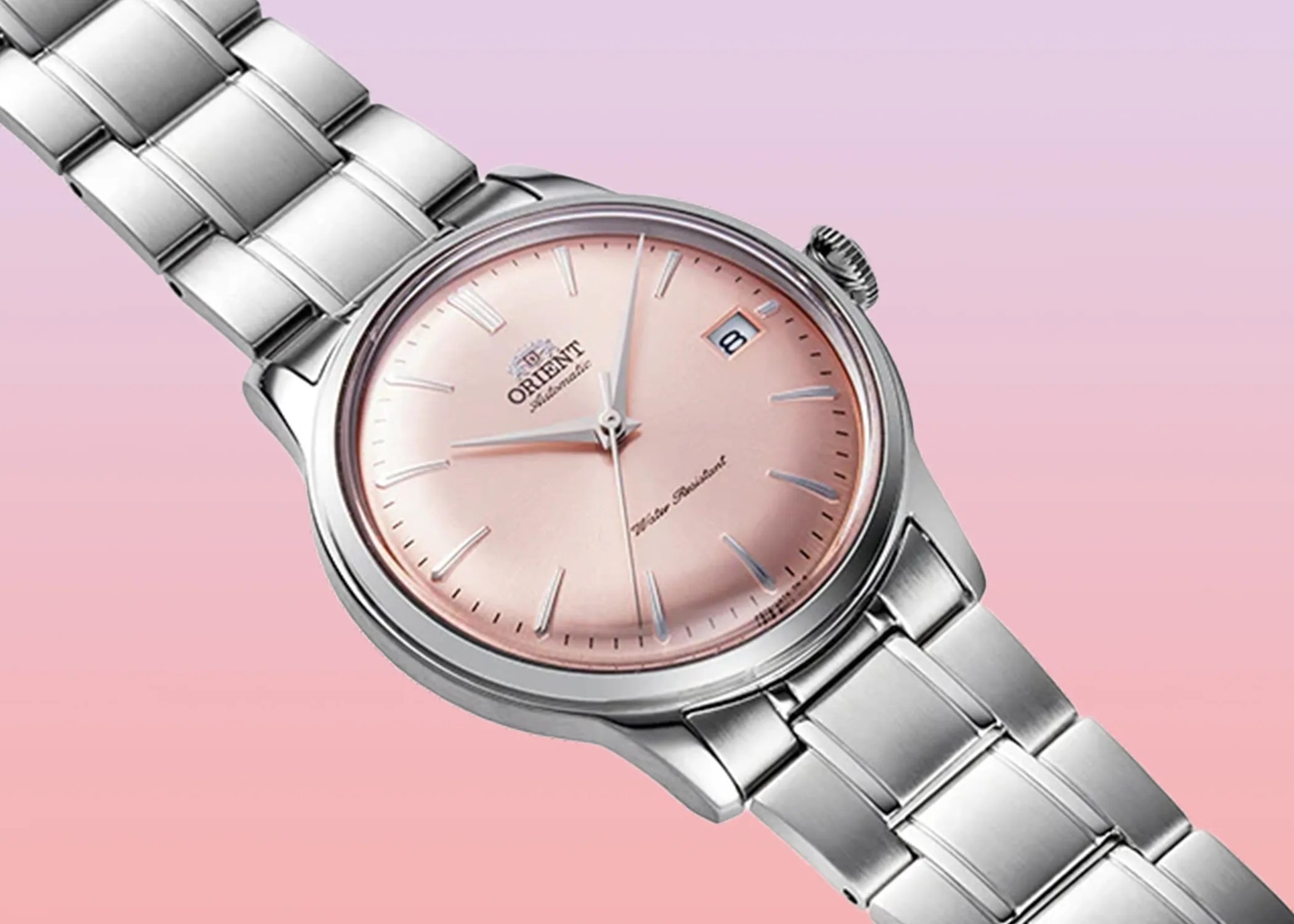 a pink orient watch against a pink background