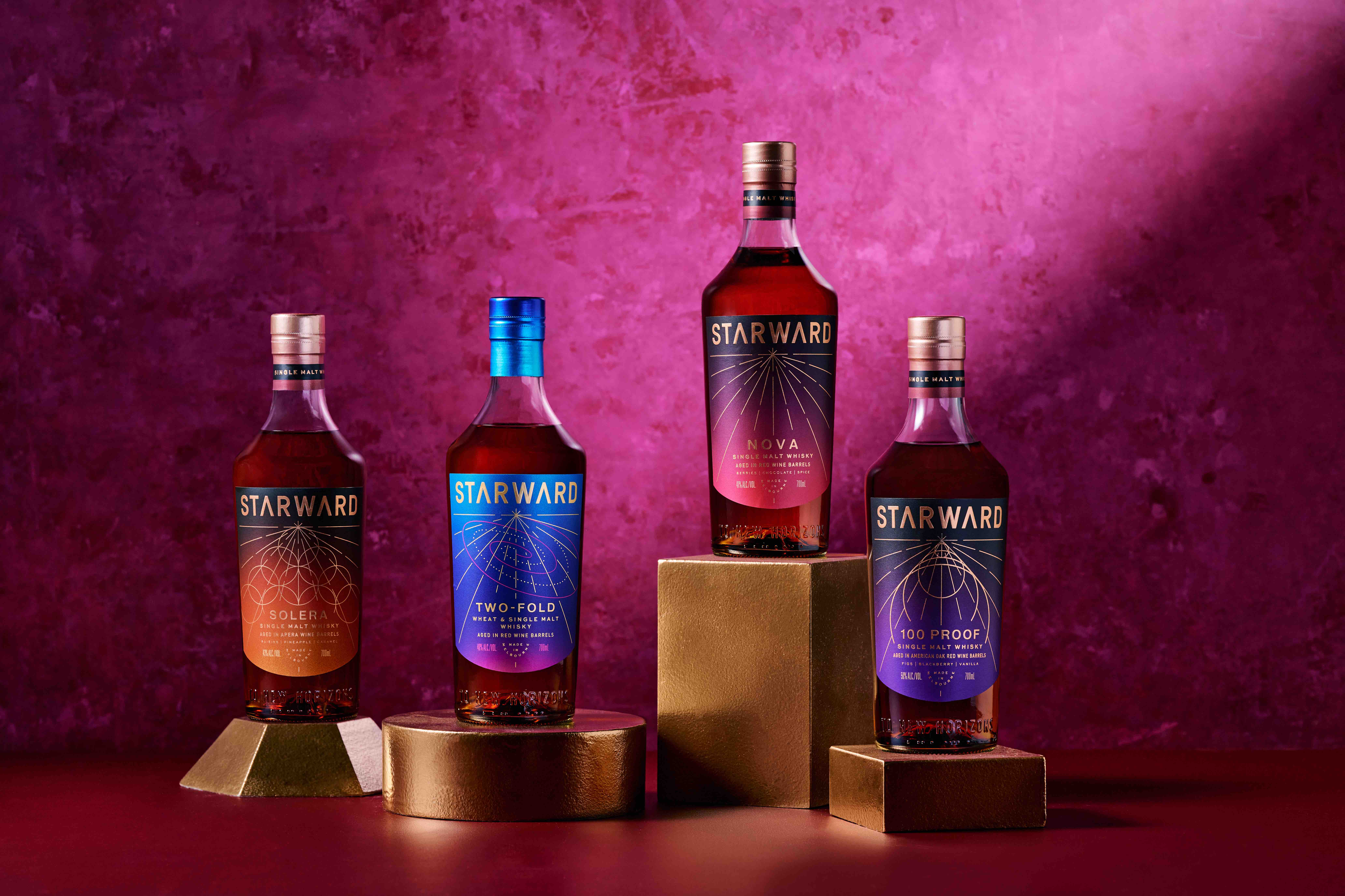 four bottles of starward whisky on display
