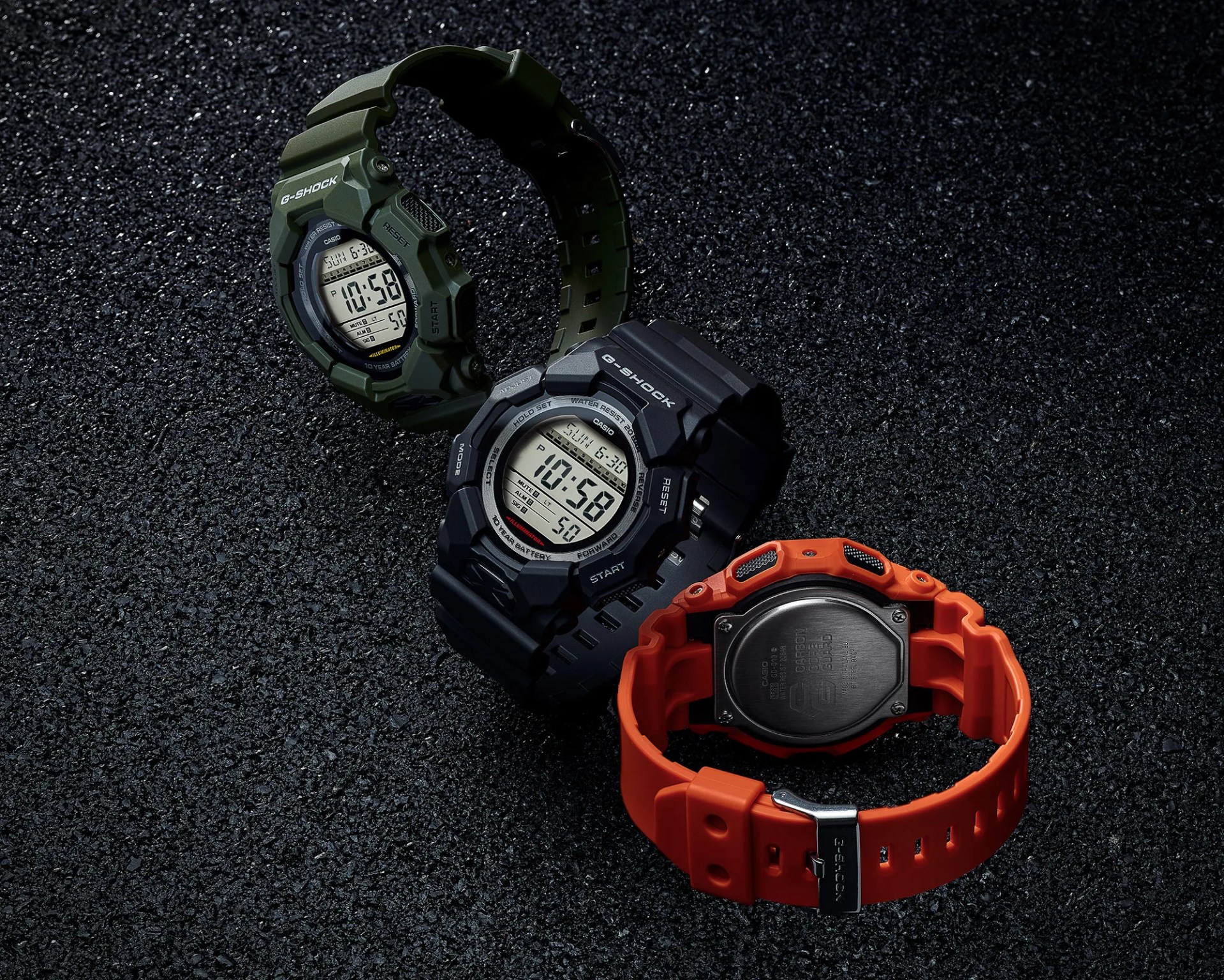 three casio g-shock watches on black material