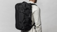 Black Ember Forge 40 Backpack shown being worn on a man's back from an angle