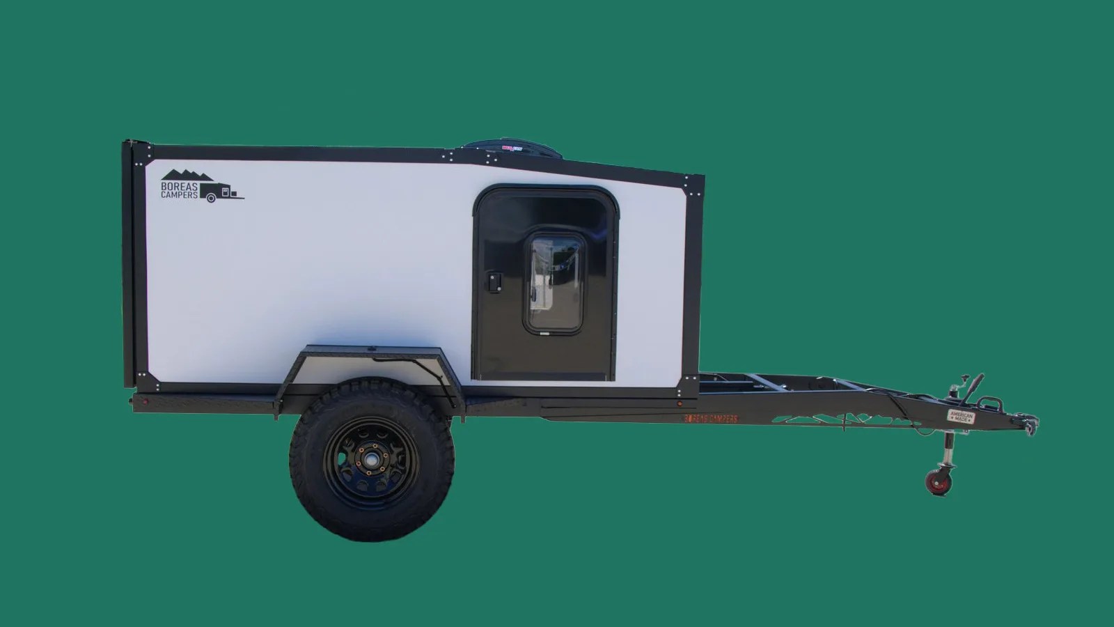 Boreas UB camp trailer viewed from profile on green color background