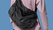 GU Ripstop Messenger Bag being worn on the back of a personal wearing a pink long sleeve