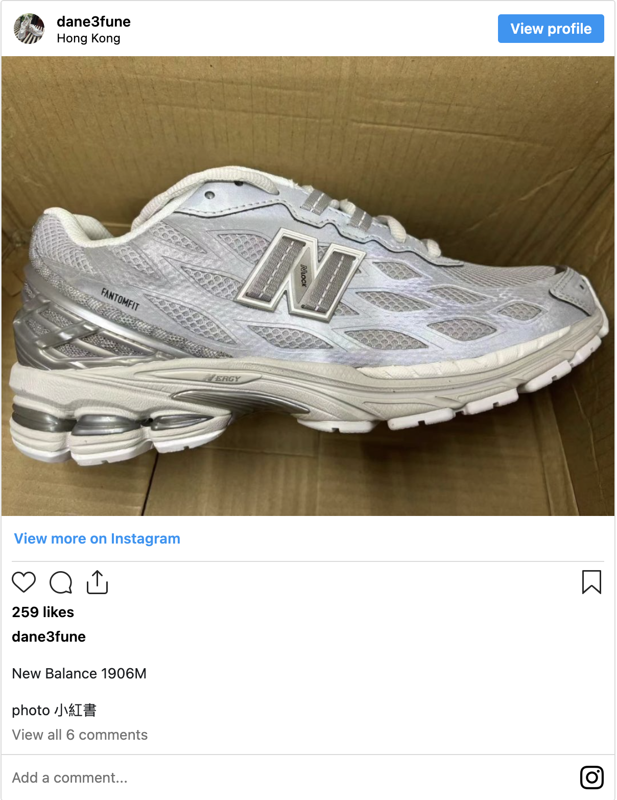 A screen shot of an Instagram post by user dane3fune showing a pair of silver and white New Balance sneakers in a cardboard box. The caption on the post readers New Balance 1906M