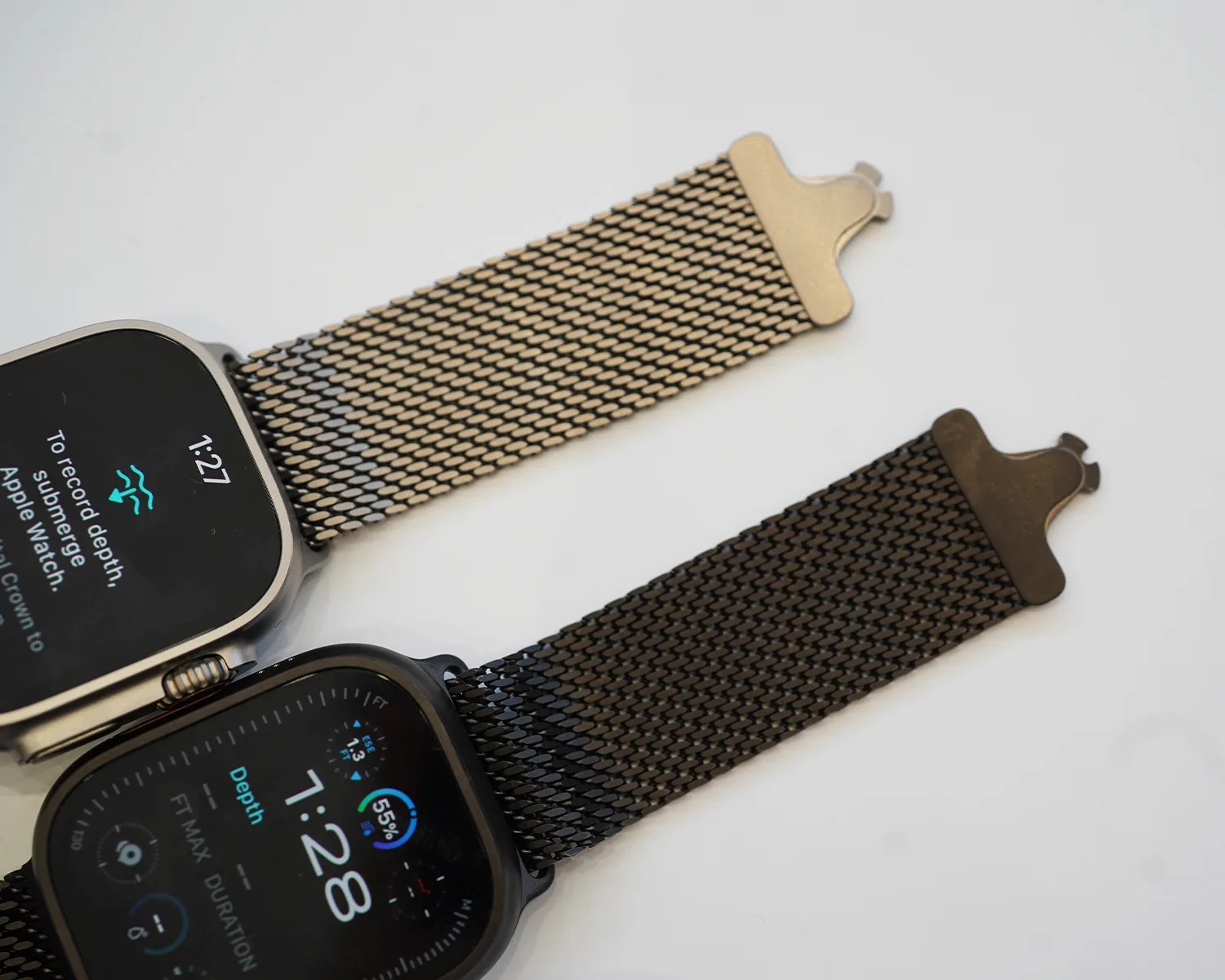 two apple watch ultras on a table