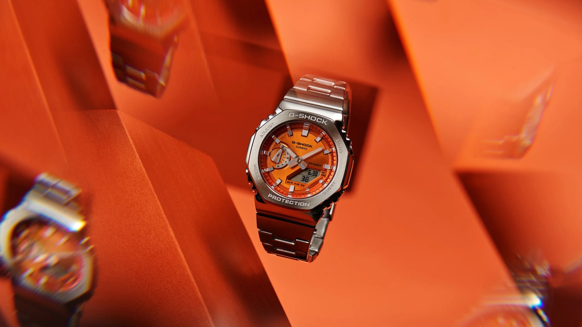 orange watch floating in air with orange background and prismatic shapes