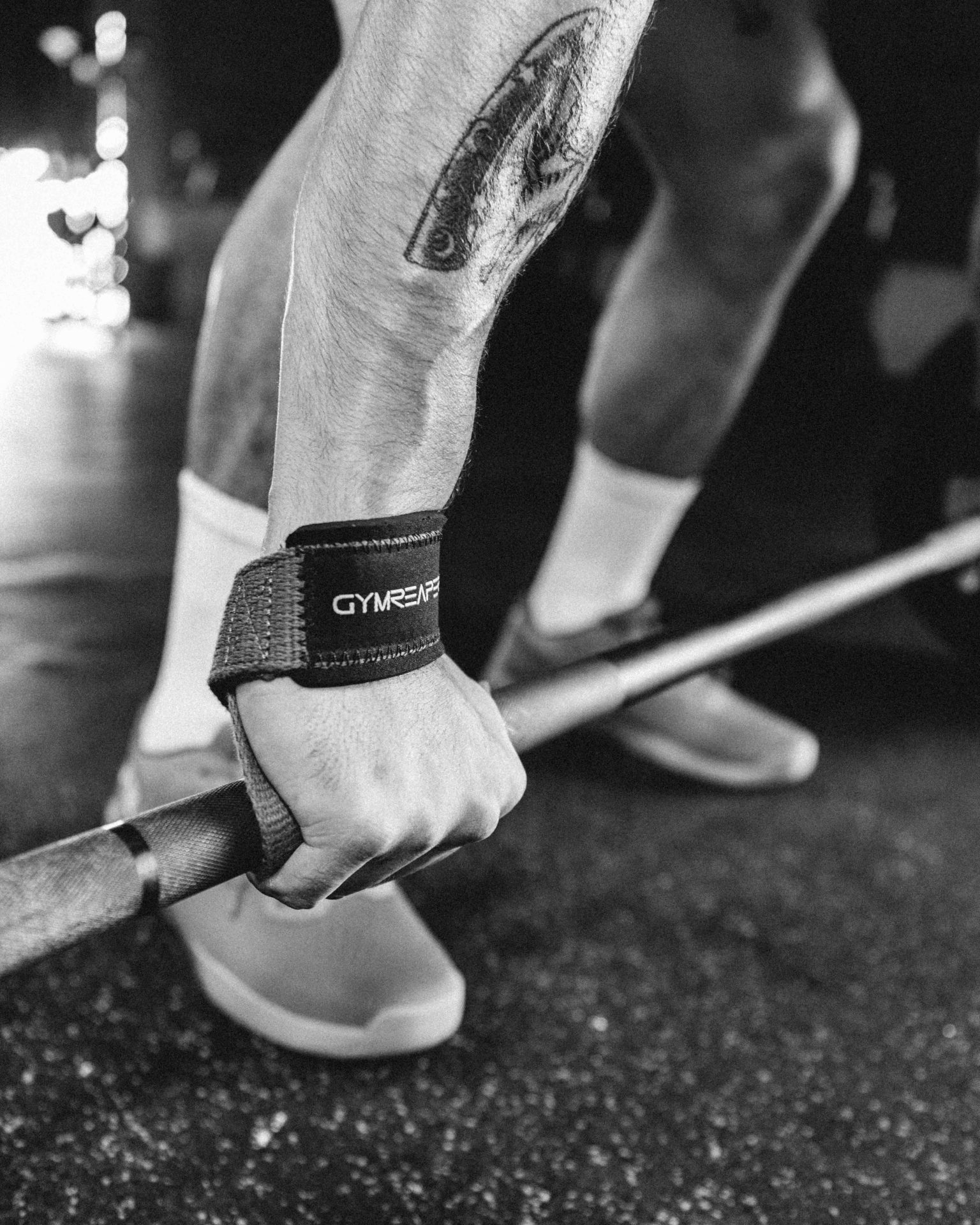 black and white photo of man in a gym