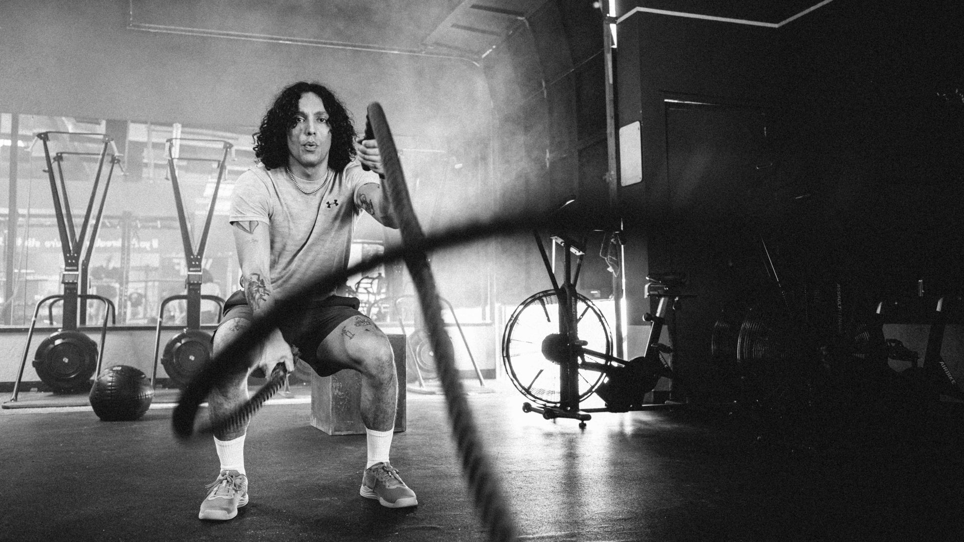 black and white photo of man in a gym