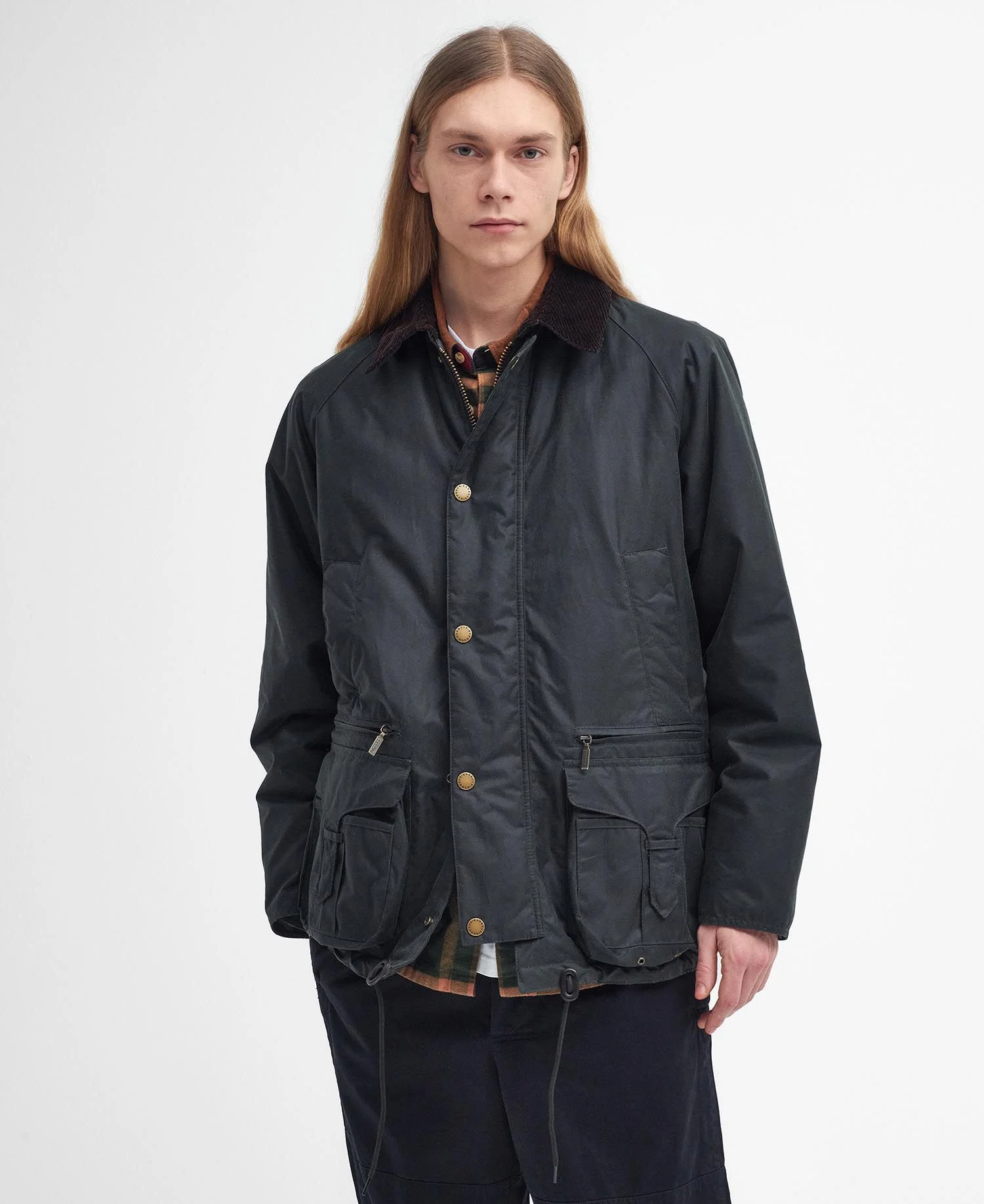 A Modified Beaufort Waxed Jacket being worn on a male model against a light grey background