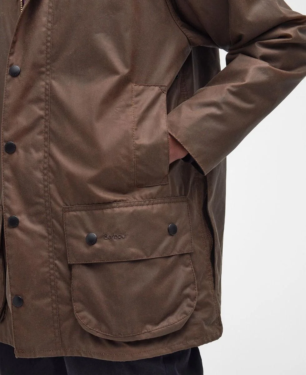 Close up of Barbou’sr Beaufort waxed canvas jacket’s front pockets with a hand inside
