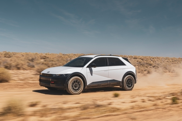 A white 2025 Hyundai Ioniq 5 XRT driving down a dusty desert road