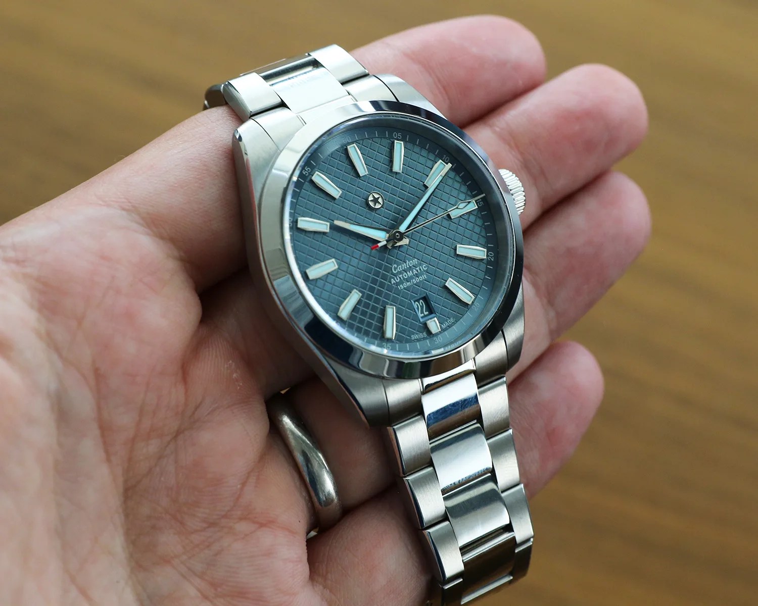 a jack mason watch held in a persons hand