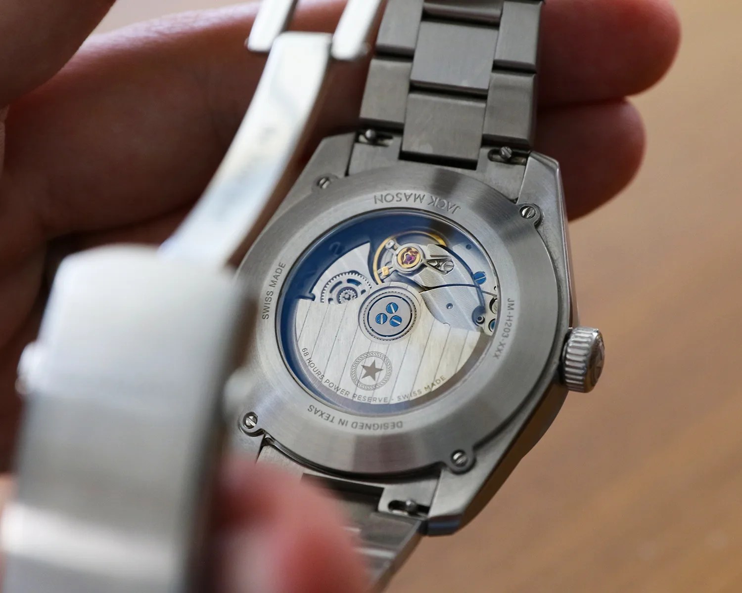 jack mason watch movement seen through a caseback