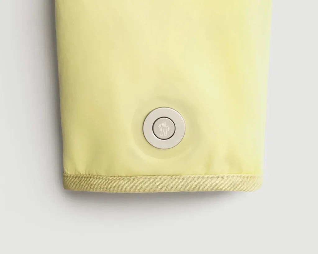 silver button on a yellow sleeve