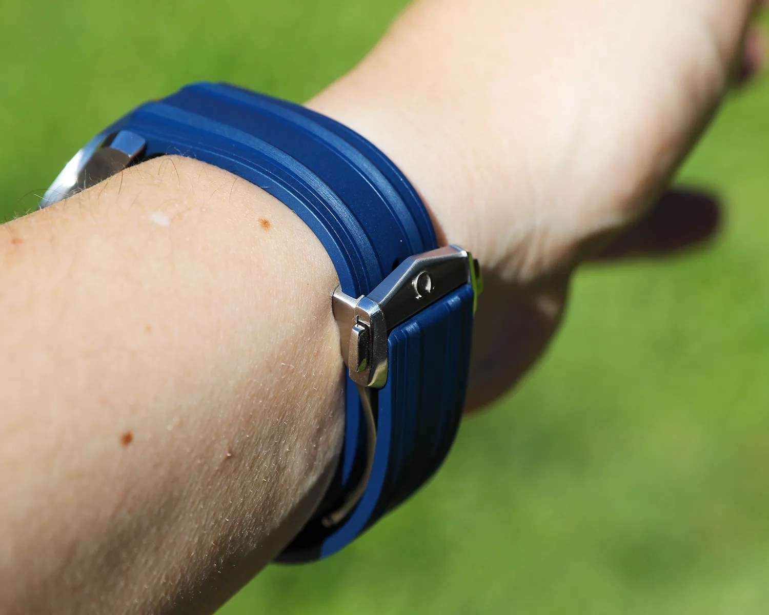 omega rubber watch strap on a mans wrist