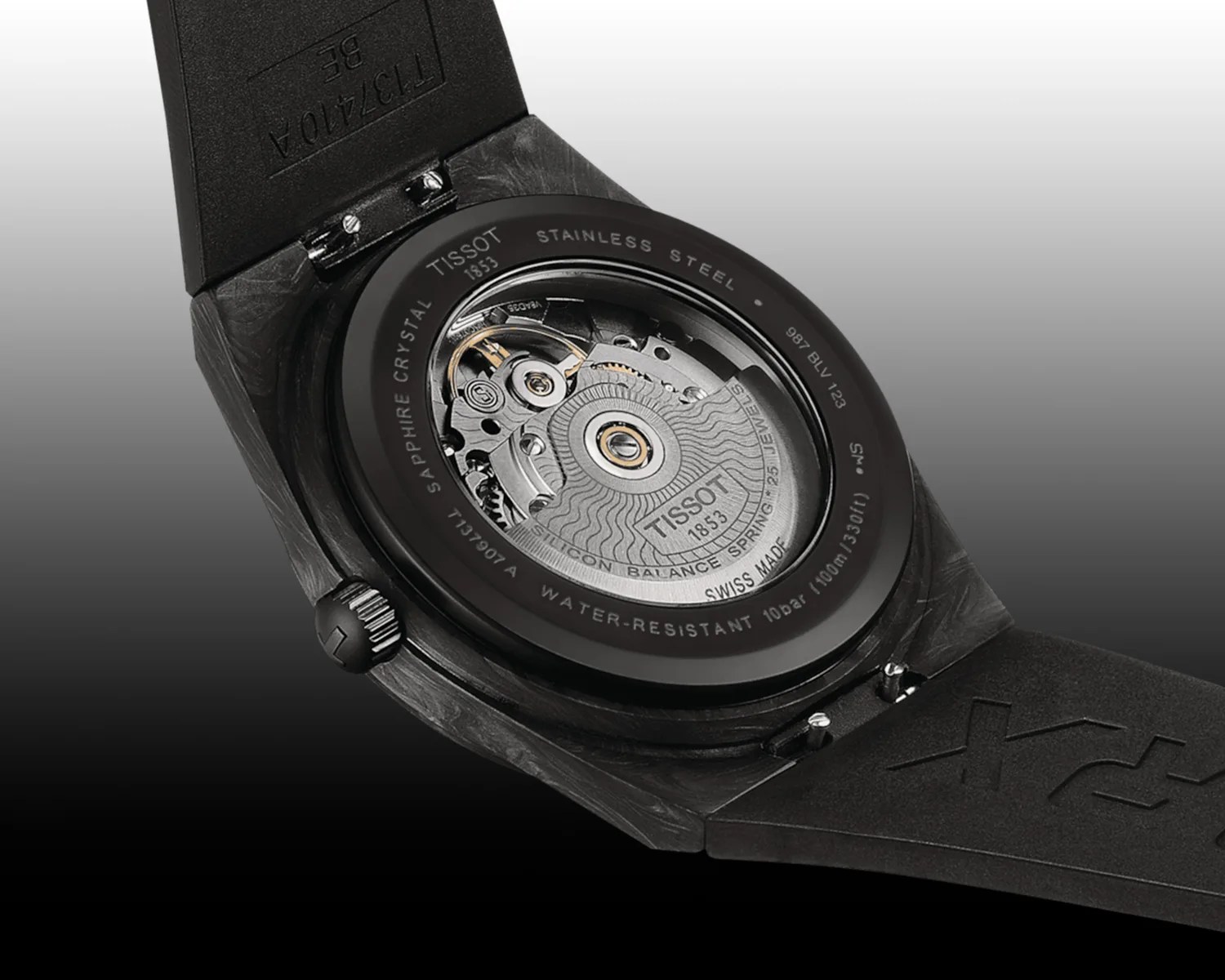 the automatic movement of a black Tissot watch seen through a display caseback