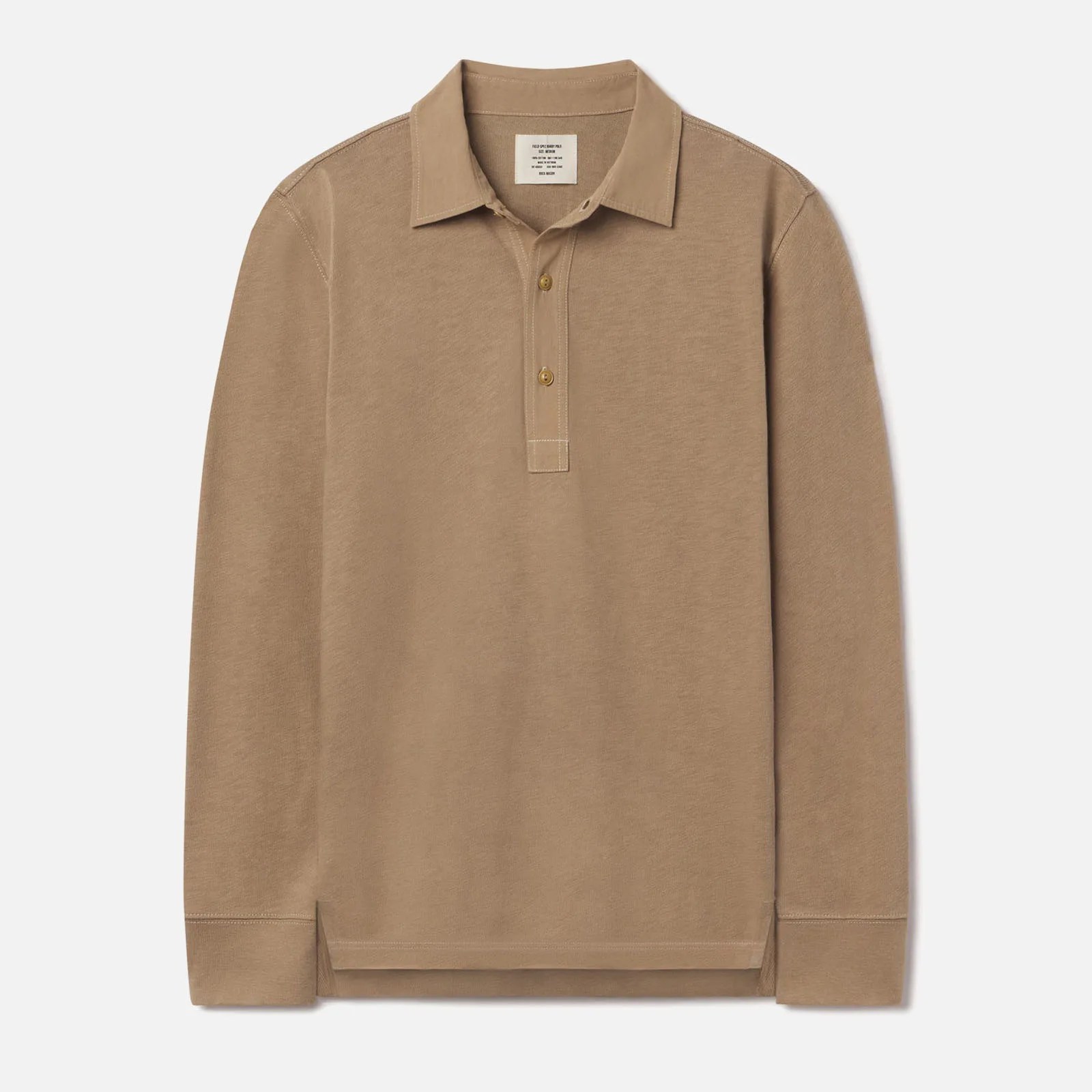 Buck Mason’s Field Spec Rugby shirt in a tan color laid flat against a light grey background