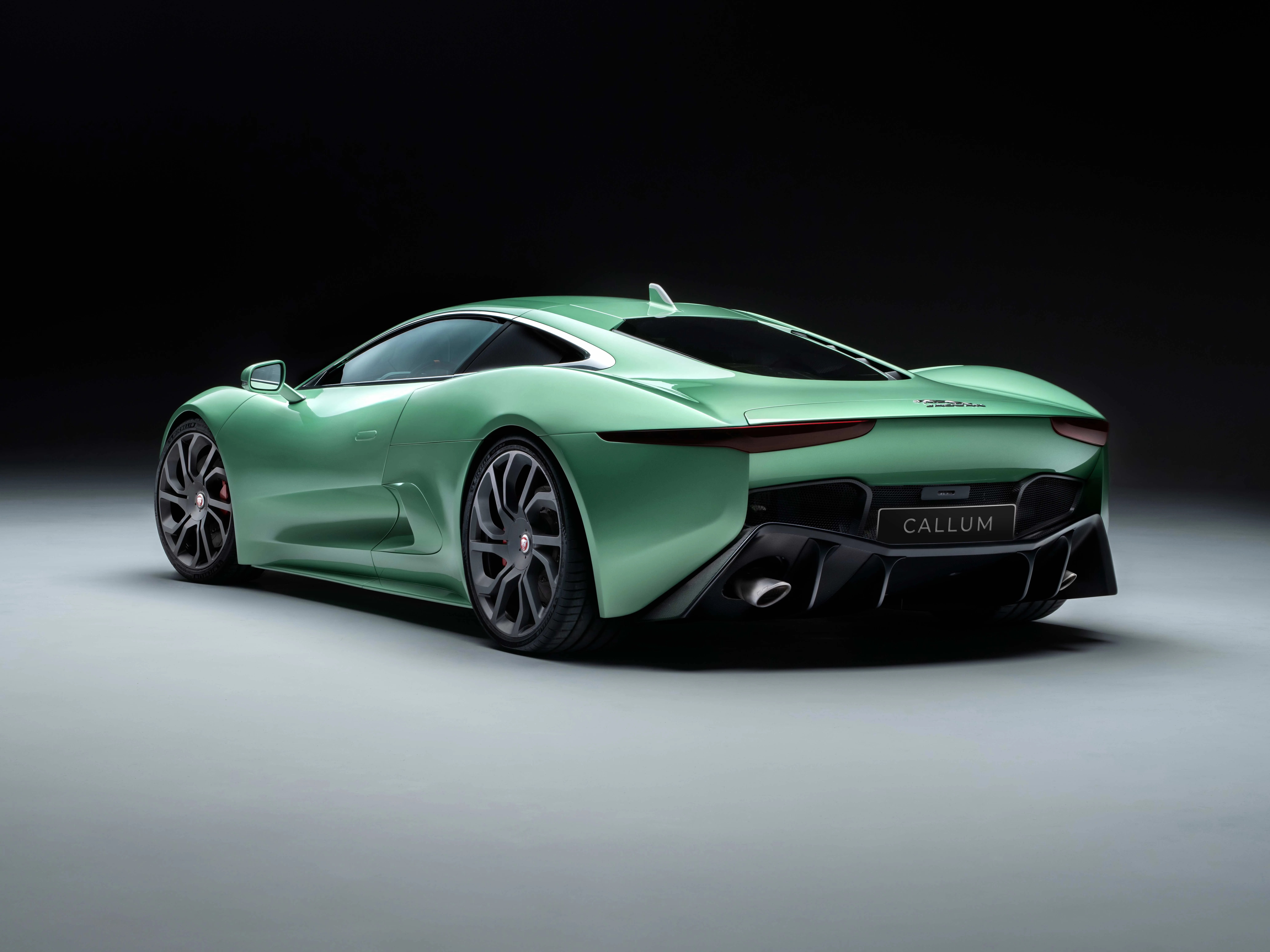 the full rear view of a green callum jaguar c x75 sports car