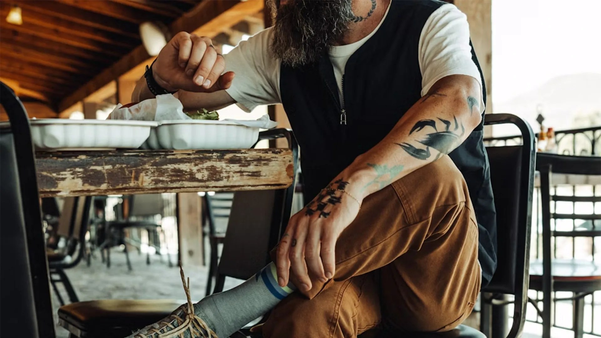person eating food while sitting and looking off to the side